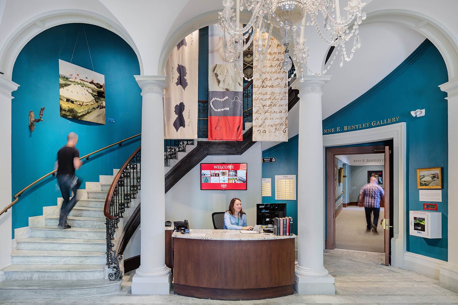 Architectural photograph of Massachusetts historical society location in Boston showing the main reception desk and staircase going up