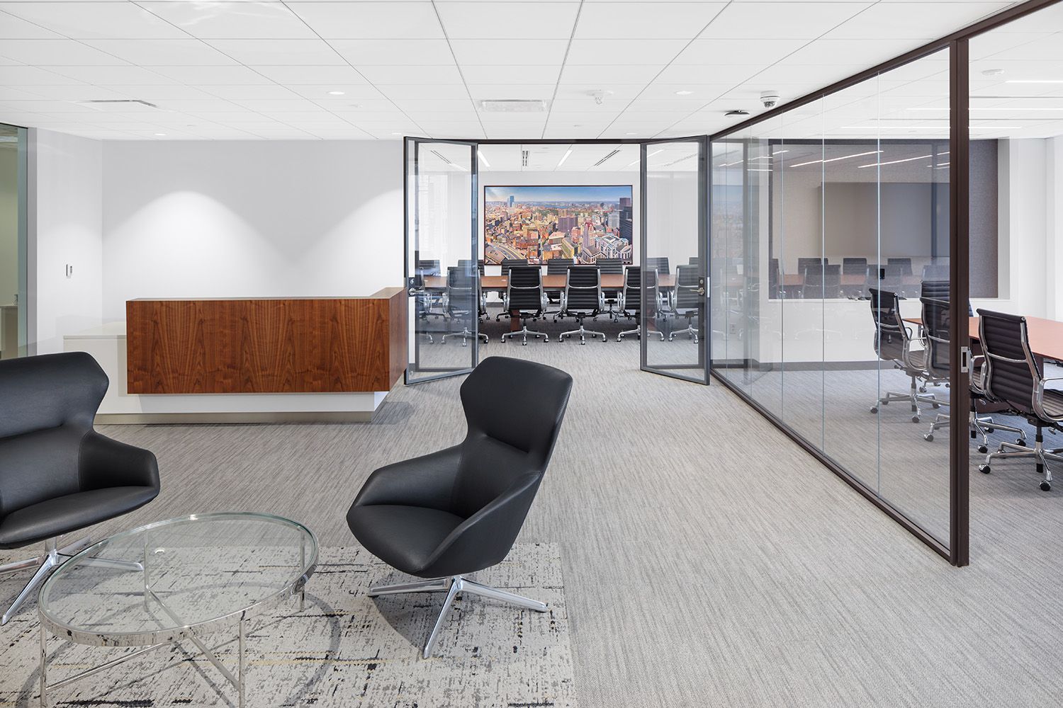 BOSTON AREA OFFICE LOCATION WITH RECEPTION DESK AND BOARDROOM TO THE SIDE TAKEN IN AN ARCHITECTURAL PHOTOGRAPHY FASHION.