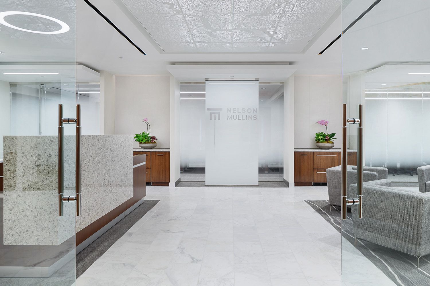 THE ENTRANCE WAY TO A NEW BOSTON OFFICE LOCATION SHOWING THE DOORS OPEN AND THE LOBBY SPACE IN THE BACKGROUND FOR NEW ENGLAND ARCHITECTS