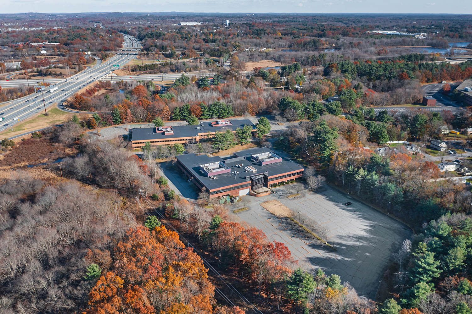 Architectural Drone image of office location in Massachusetts showing the building and available parking spaces