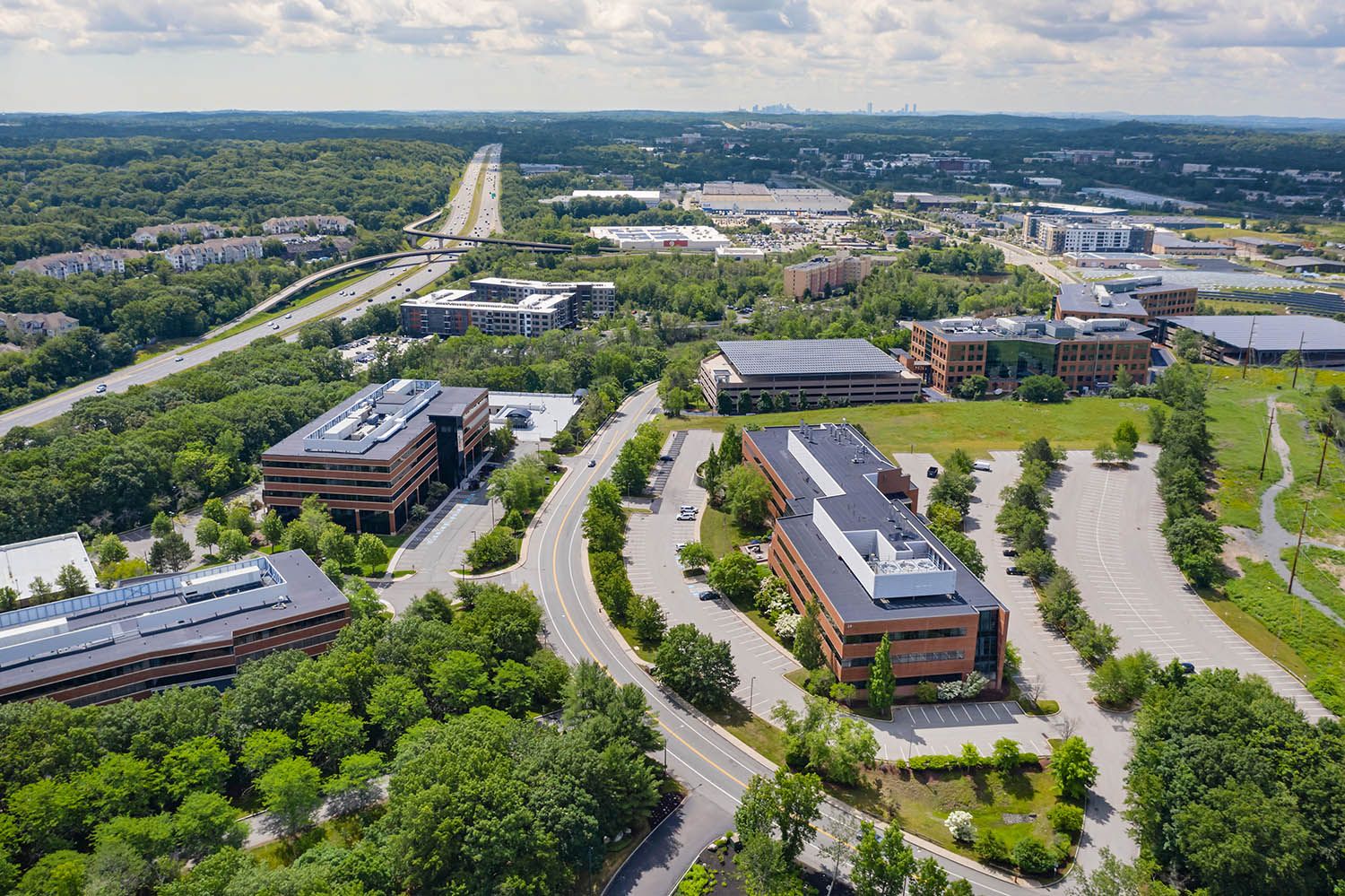 Architectural aerial photograph of office building near Boston showing the transport links available.