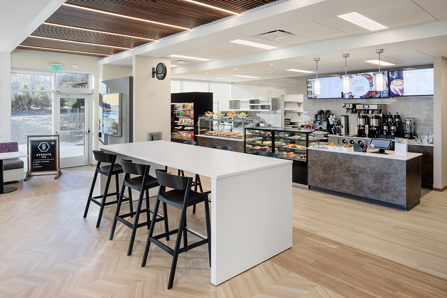 ANGLED VIEW OF DINING AREA FACILITIES IN A NEWLY OPEN HEALTHCARE CORPORATE OFFICE SPACE FOR THE ARCHITECTURAL DESIGN TEAM