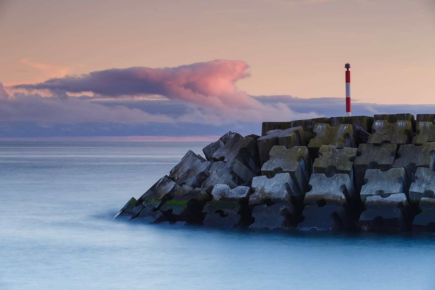 Color landscape photograph of Terceira Island in the Azores Portugal, showing a section of the sea protection measures around harbor