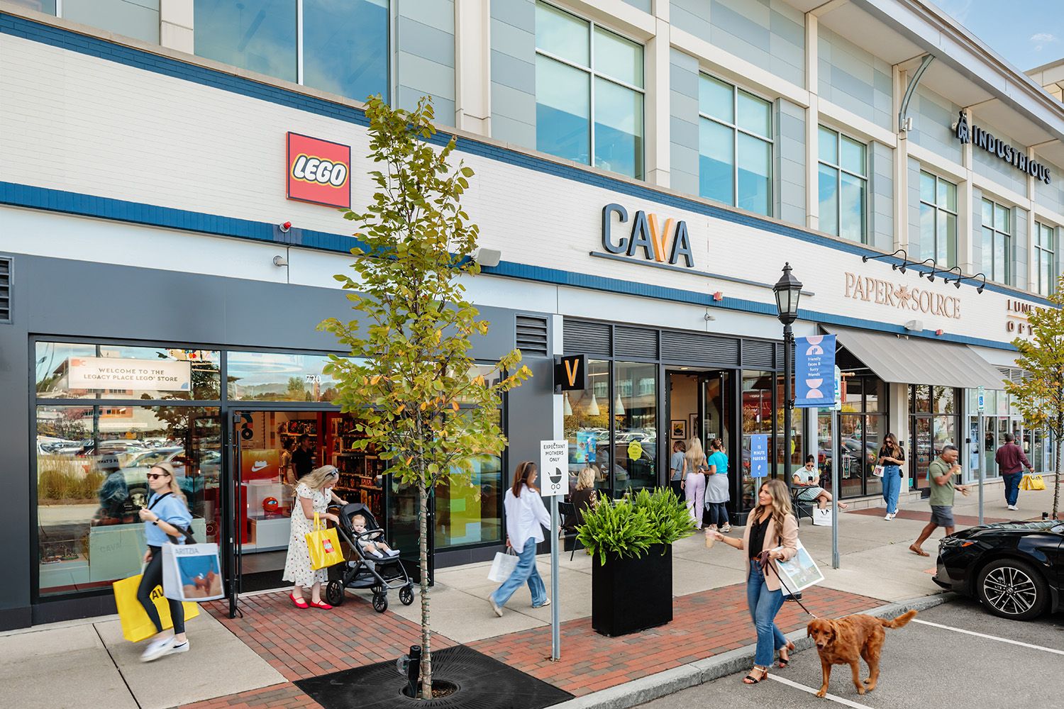 RESTAURANT PHOTOGRAPHY FROM BOSTON SHOWING THE EXTERIOR OF THE RETAIL SPACE IN AN ARCHITECTURAL STYLE WITH PEOPLE ON SIDEWALK OUTSIDE.