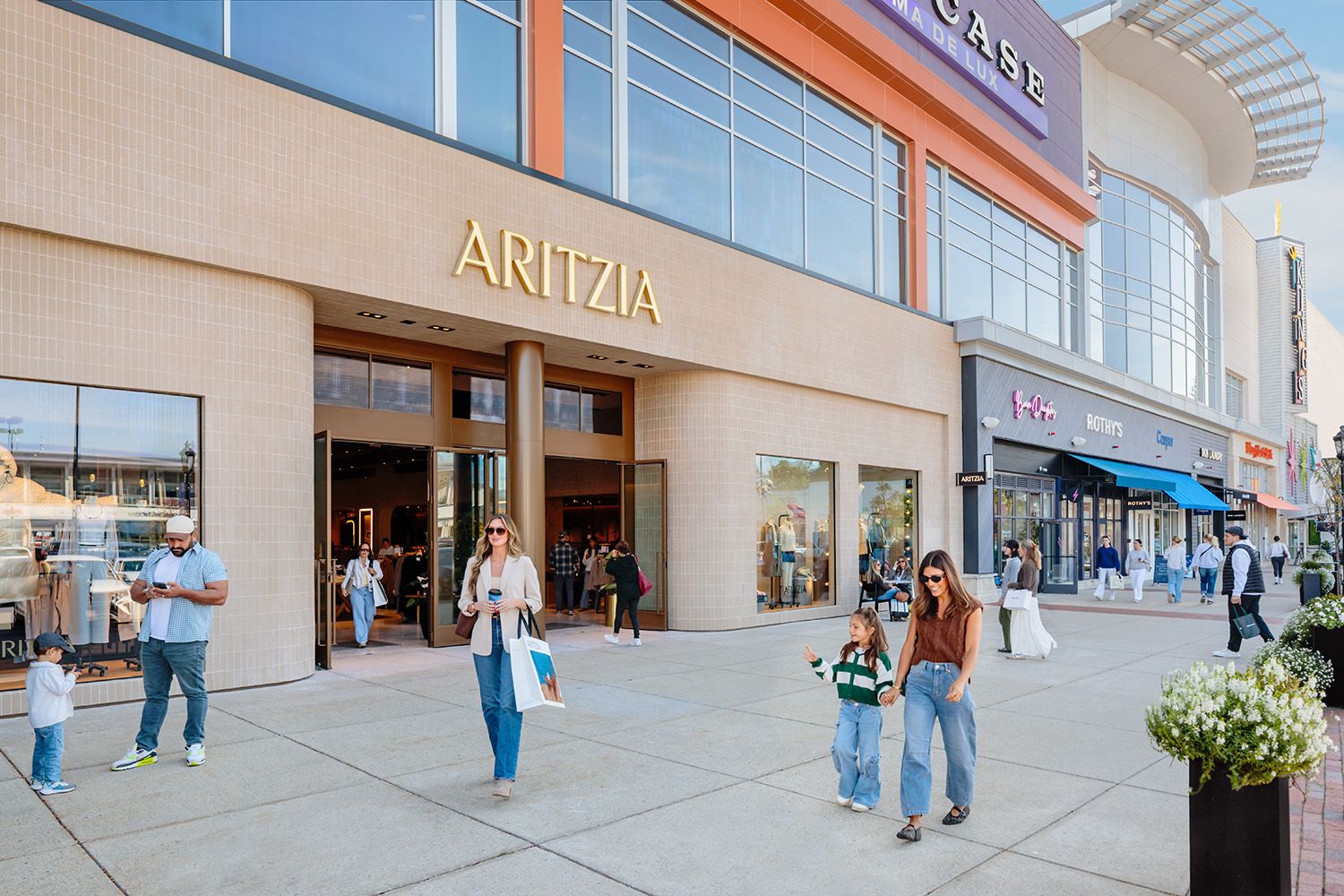 PHOTOGRAPH OF ARCHITECTURAL DETAILS AT A BOSTON AREA MALL SHOWING THE RETAIL FACILITIES WITH PEOPLE ON THE SIDEWALKS OUT THE MAIN STORES
