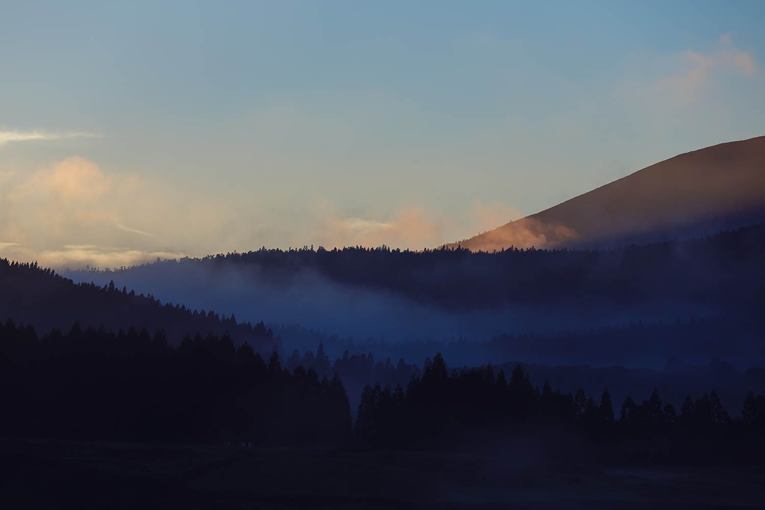 Color landscape photograph of Terceira Island in the Azores Portugal, showing fog in the hills