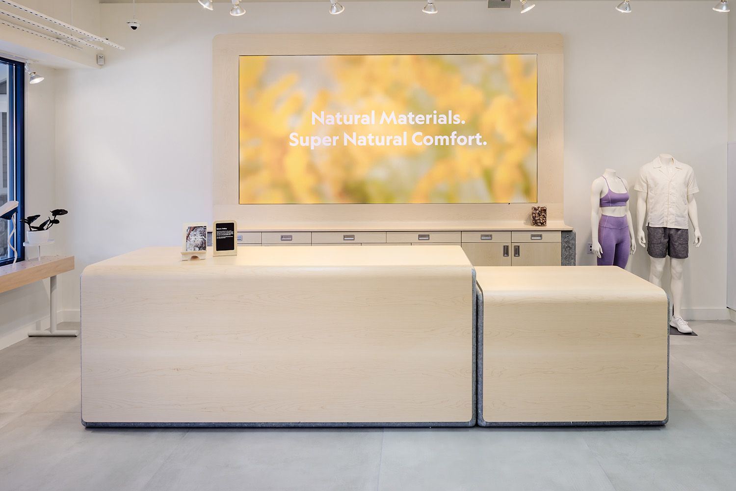 THE CHECK OUT REGISTER AREA OF A SHOE STORE DESIGNED BY A BOSTON ARCHITECTURAL COMPANY TO SHOW THE ARTWORK AND LAYOUT