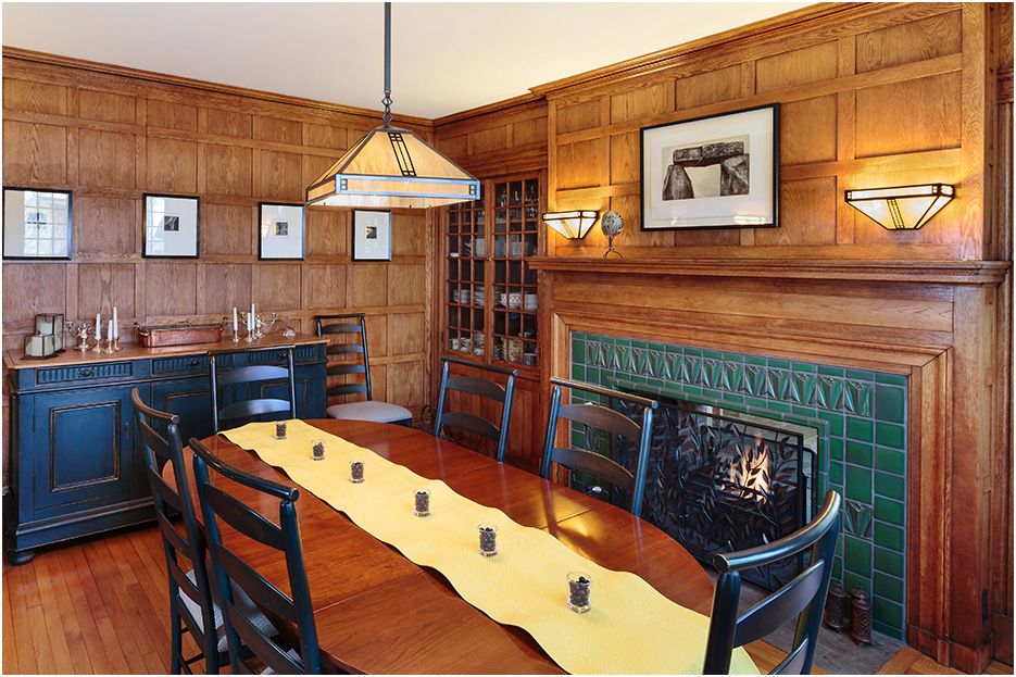Architectural photograph of Boston home renovations in Newton, showing fireplace in the dining room area, work by Custom Works GC