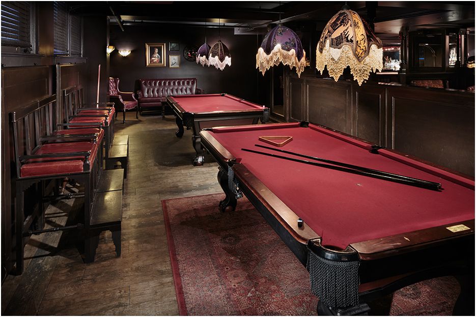 Architectural restaurant and bar photography of Carrie Nation in downtown Boston MA showing  the pool tables and architectural details.