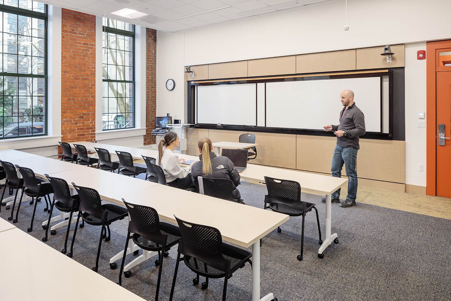 Boston College photography for local architects showing one of the smaller lecture spaces with people attending and discussing