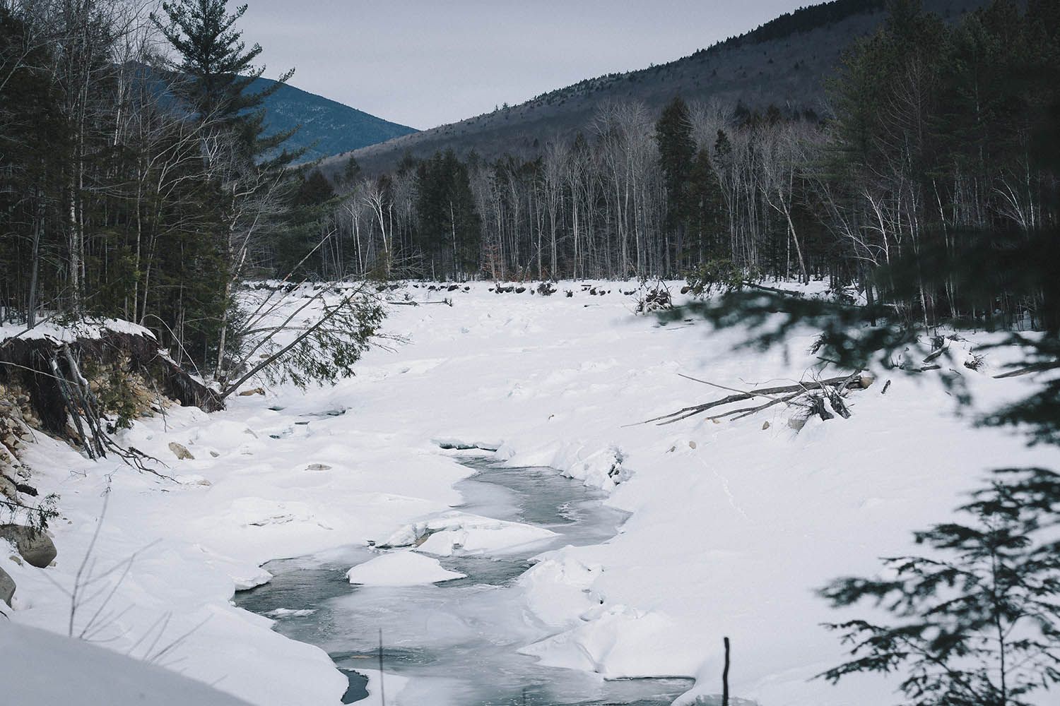 Color landscape photograph showing frozen river in winter by architecture and landscape photographer Roberto Farren