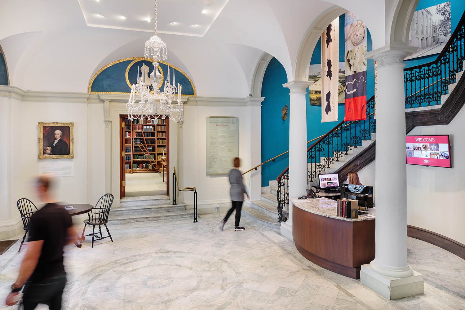 Architectural photograph of Massachusetts historical society location in Boston showing the main reception desk and staircase going up