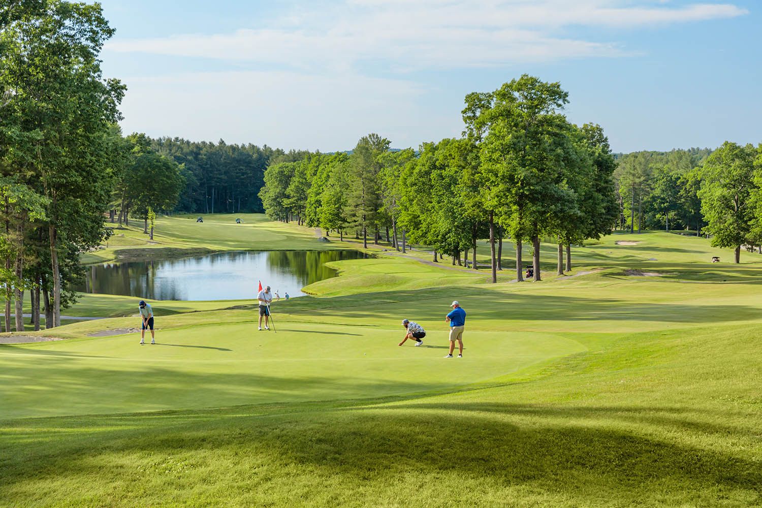 Architectural Images for Boston area golf course, Shaker Hills  Harvard MA showing golfers on the green about to putt course in background