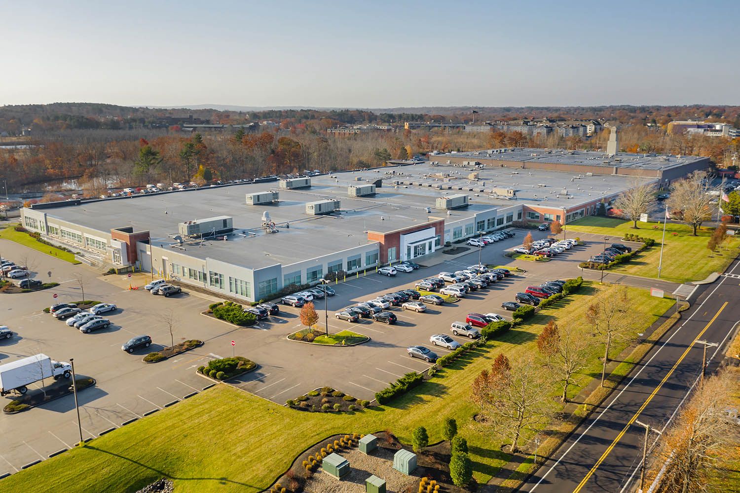 Architectural Drone image of manufacturing complex showing the length and size of building and the surrounding environment