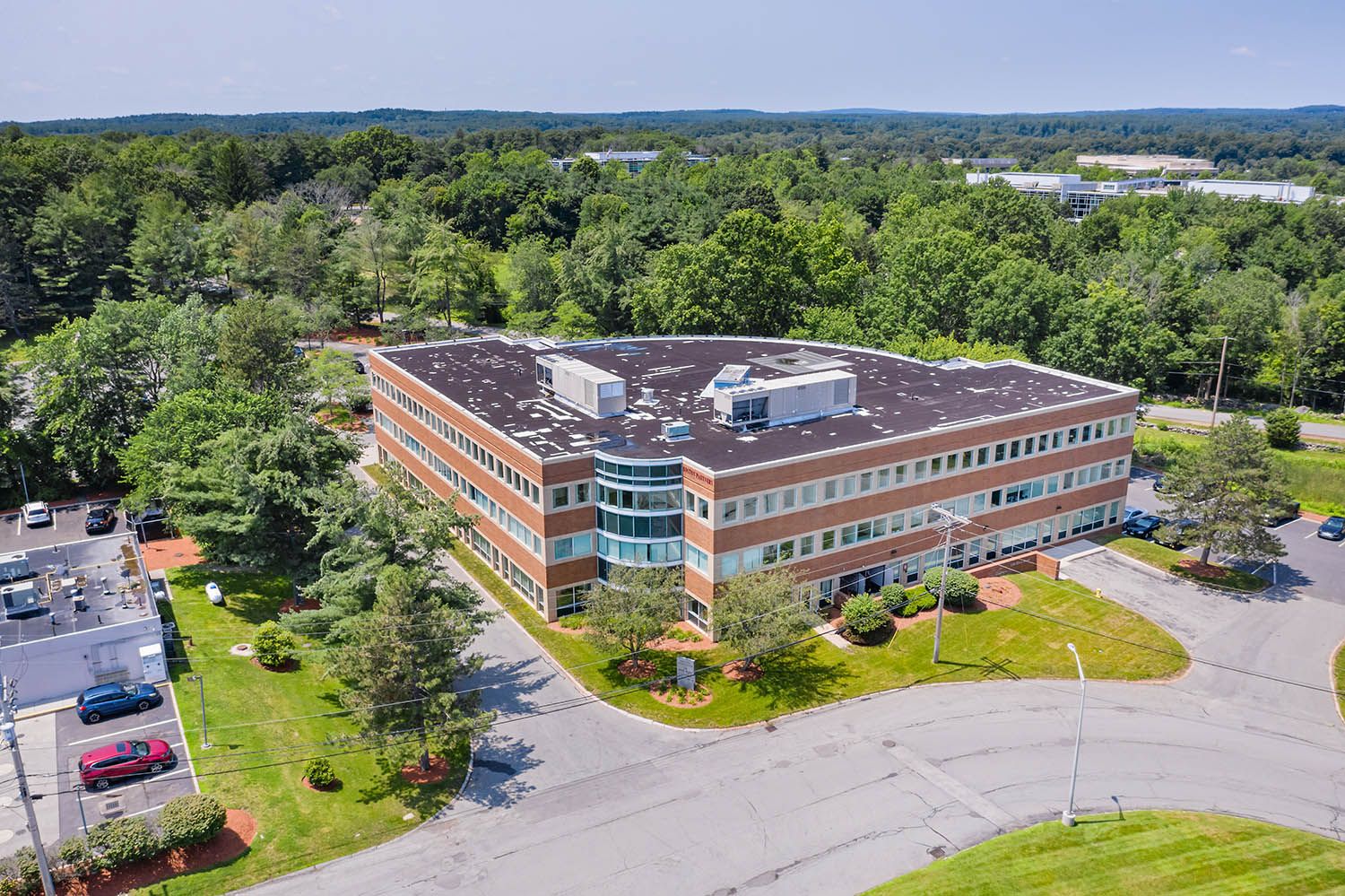 Architectural Drone image of office complex near Boston in New England to show the building in it's rural setting.