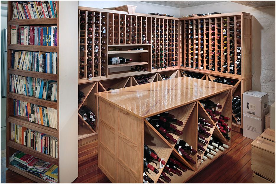 Architectural photograph of Boston home renovations in Newton, showing hidden wine storage vault and architectural details and design.