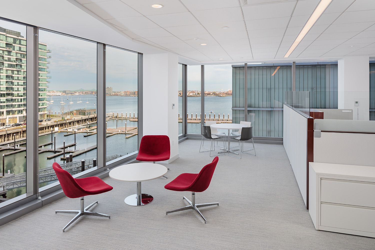 AND SMALL BREAKOUT AREA WITH WINDOW VIEWS OVERLOOKING THE SEAPORT AREA OF BOSTON IN A NEWLY DESIGNED OFFICE SPACE