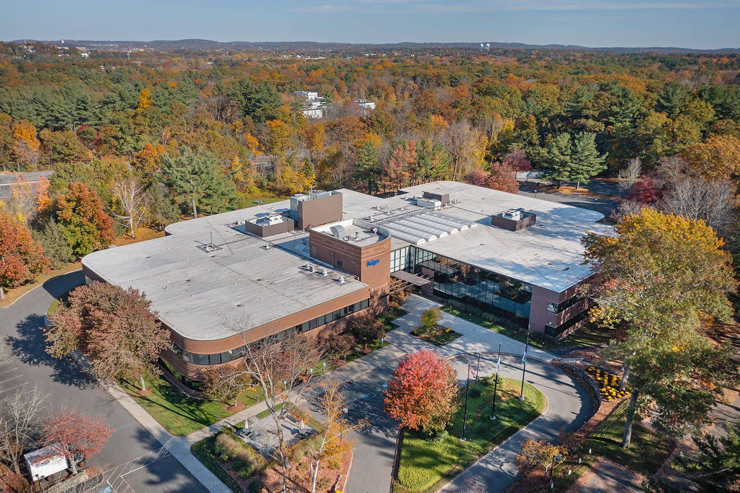 Architectural Drone image showing close details of the building and it's location surrounded by trees and nature