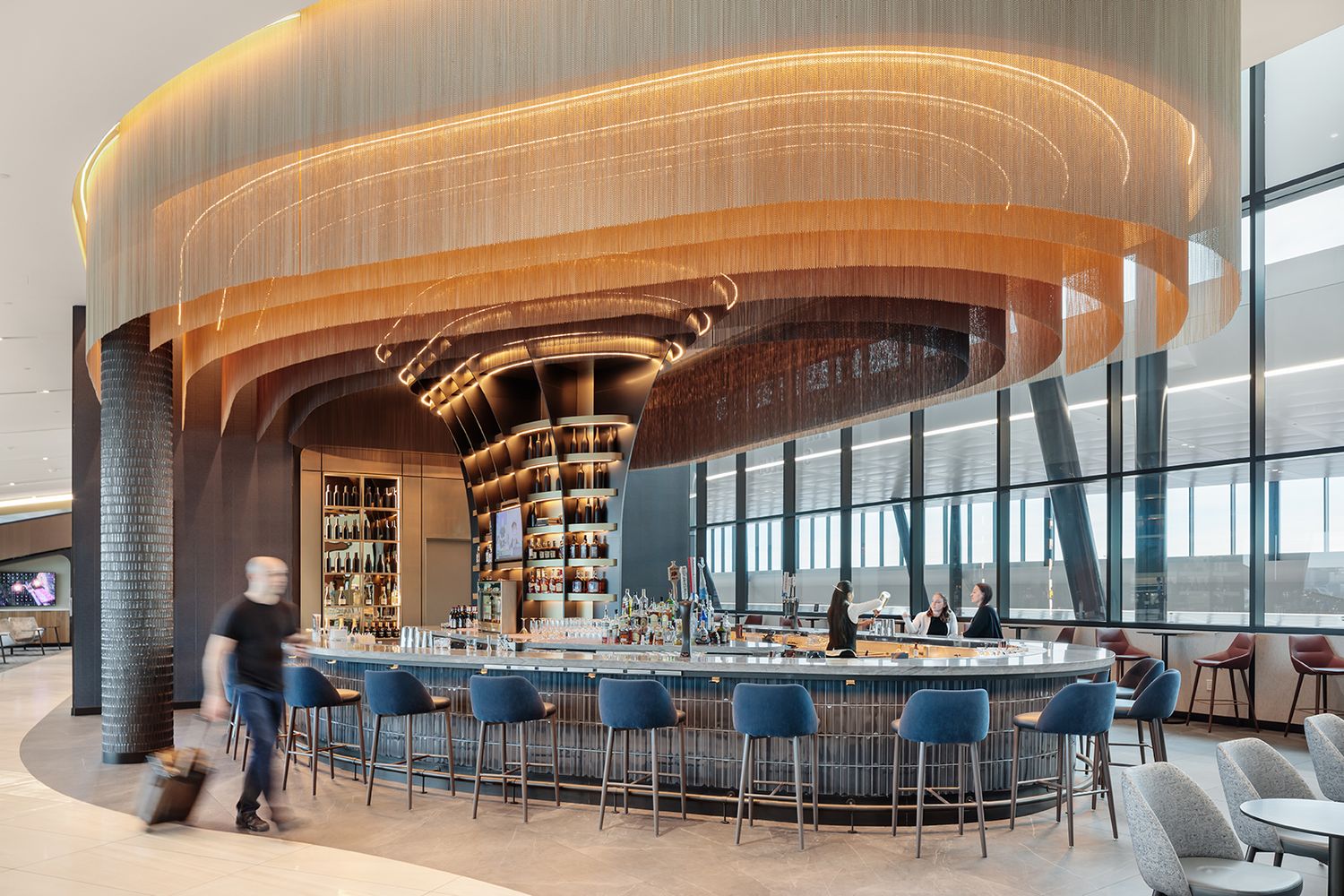 ARCHITECTURE PHOTOGRAPHY OF BOSTON LOGAN DELTA AIRPORT LOUNGE FOR CBRE ARCHITECTS SHOWING THE MAIN BAR AND SEATING AREA IN DESIGNED SPACE