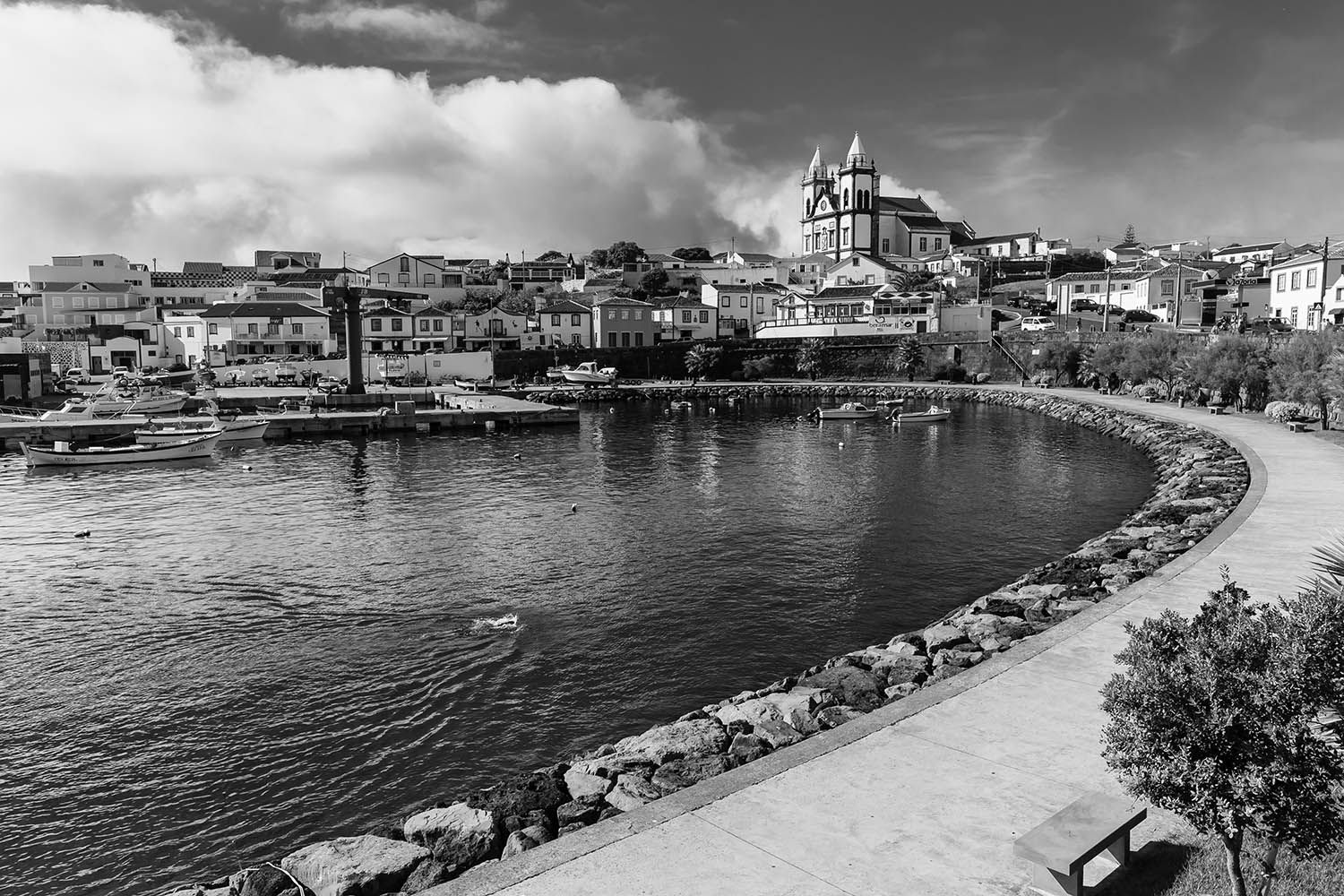 BLACK AND WHITE LANDSCAPE PHOTOGRAPH TAKEN IN THE AZORES SHOWING HARBOR AND CHURCH