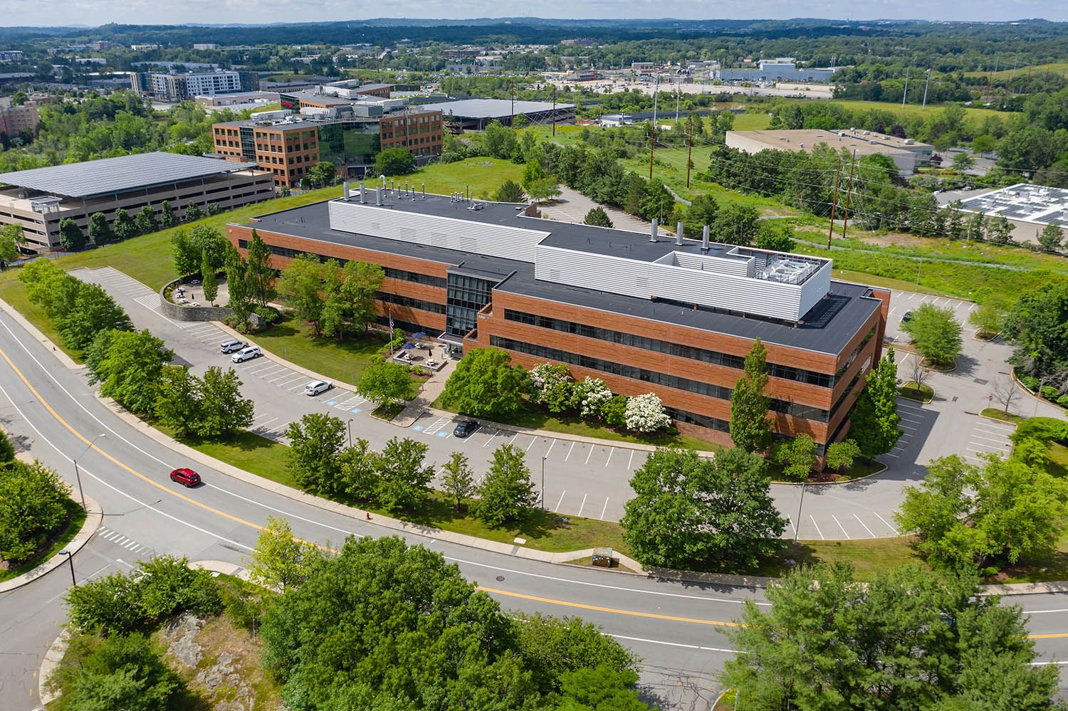 Architectural aerial photograph of new office space location set by access road and lots of green space near Boston MA