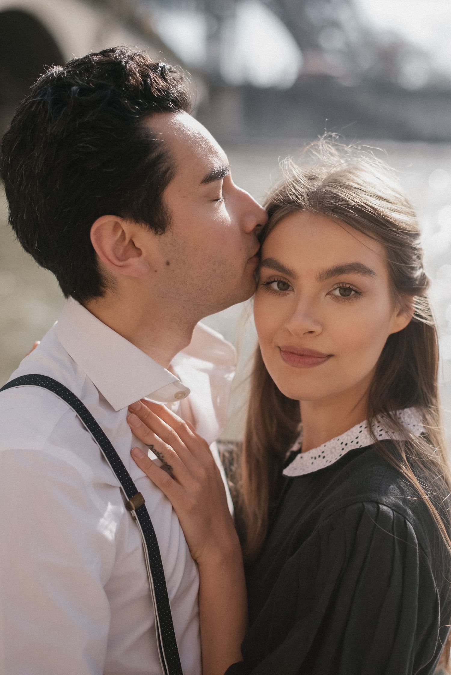 Romantic portrait of couple in vintage style clothing near Eiffel Tower.