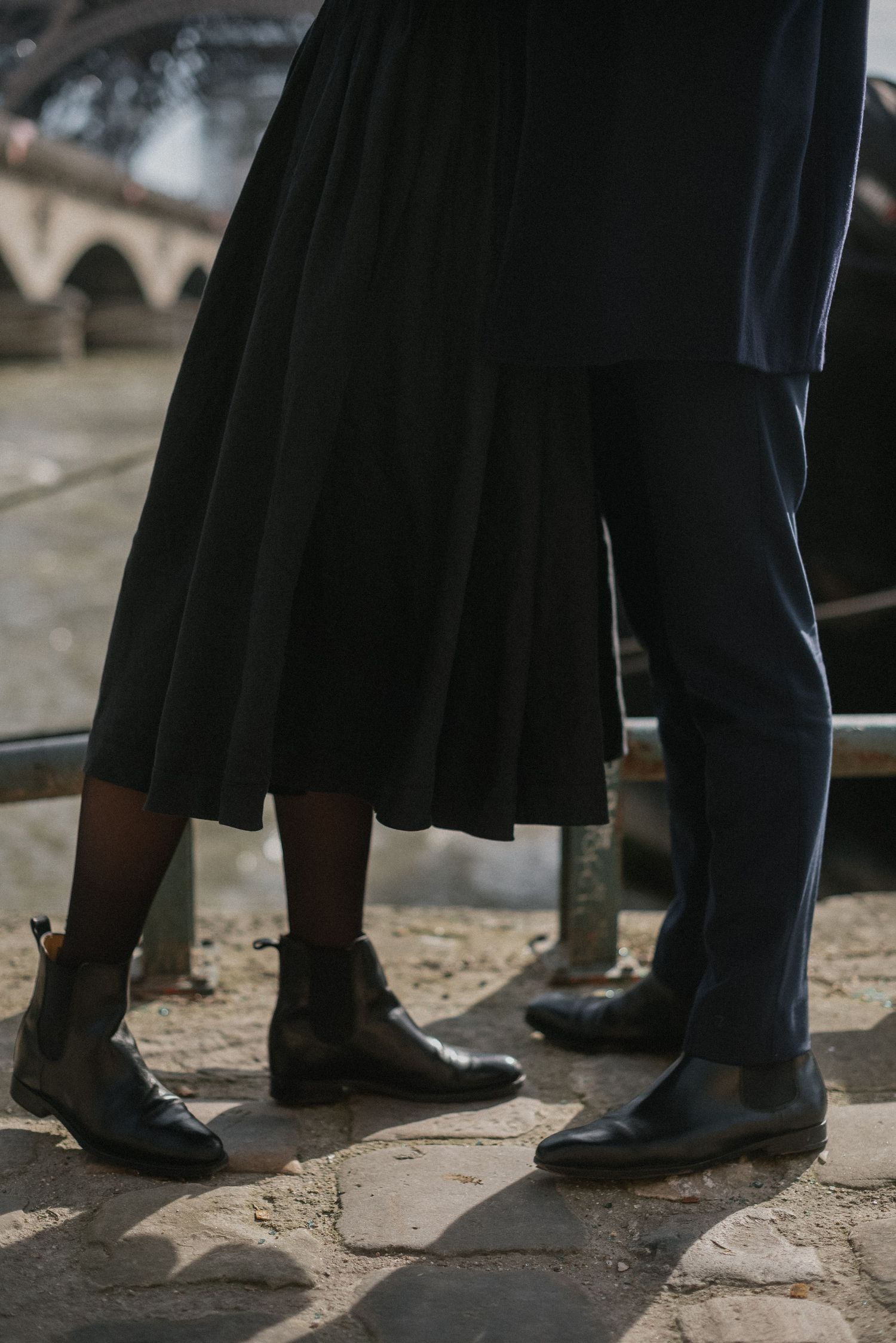 Close-up of feet and flowing dress near the Seine River in Paris.