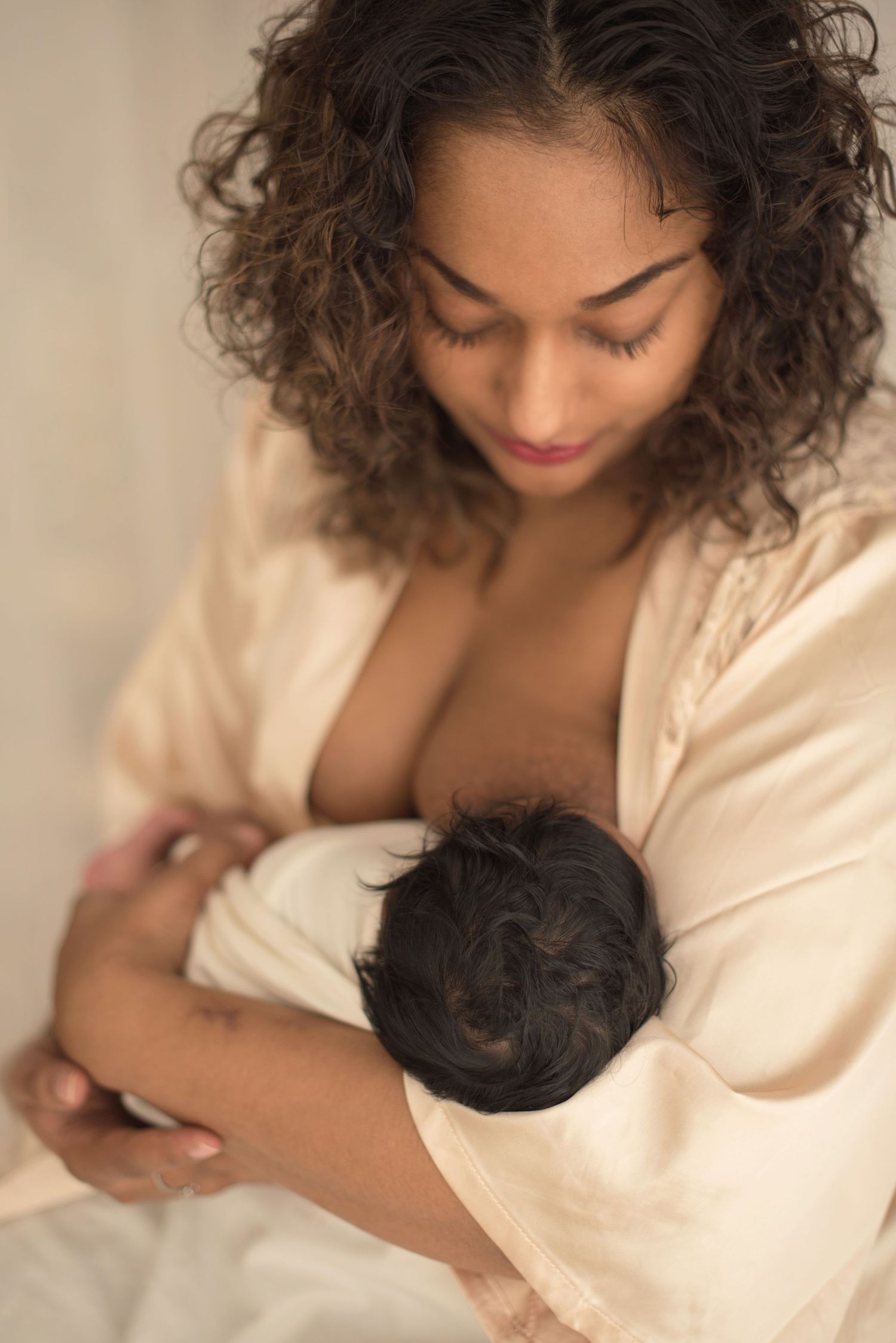 Intimate portrait in soft natural lighting with cream tones.