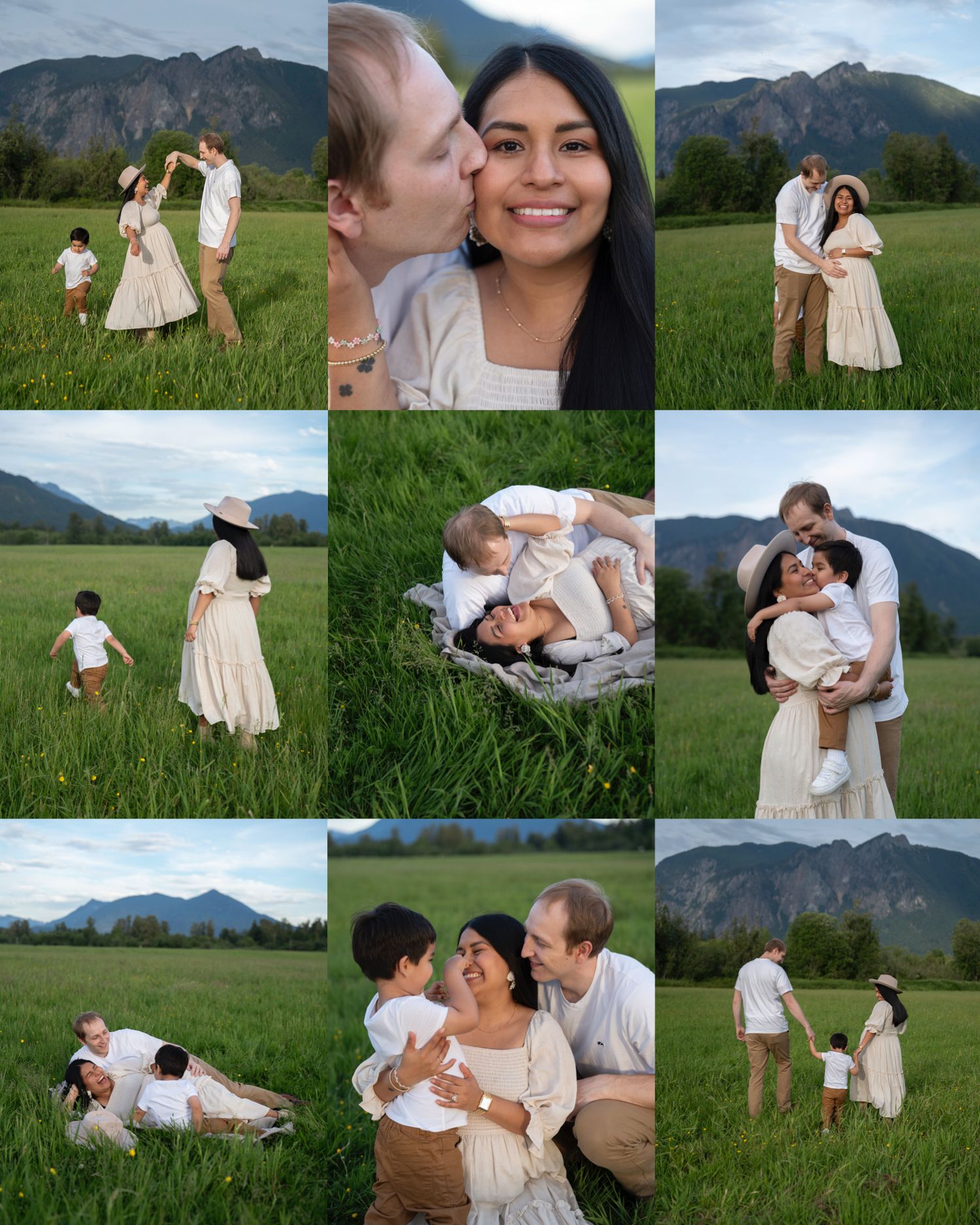 A family poses together in a lush green meadow with dramatic mountain peaks rising in the background.