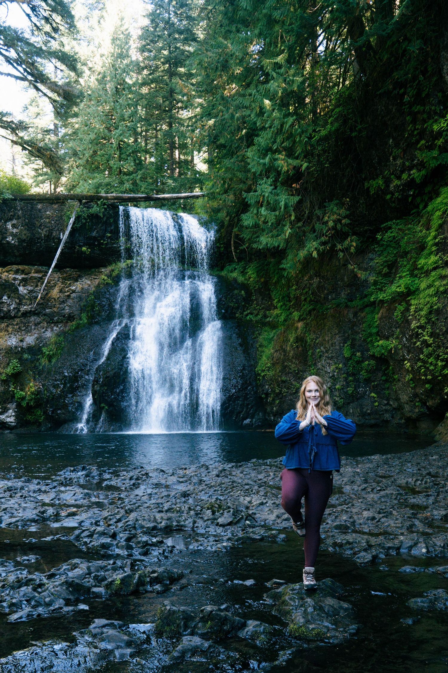 Four scenic views of a majestic waterfall cascading over rocky cliffs in a lush forest setting during daytime.