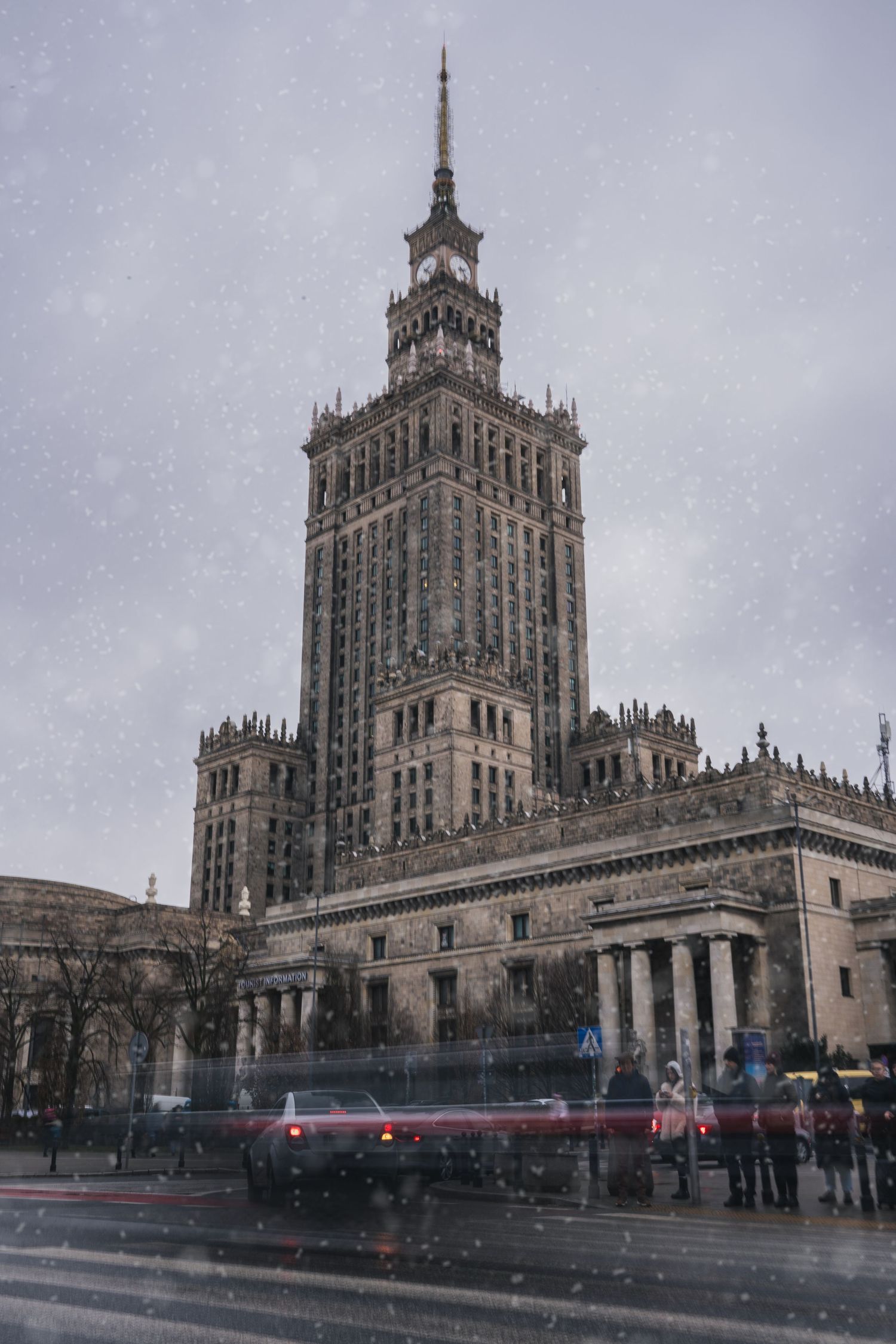fast paced snowy warsaw downtown with cars moving fast enough to create a blur