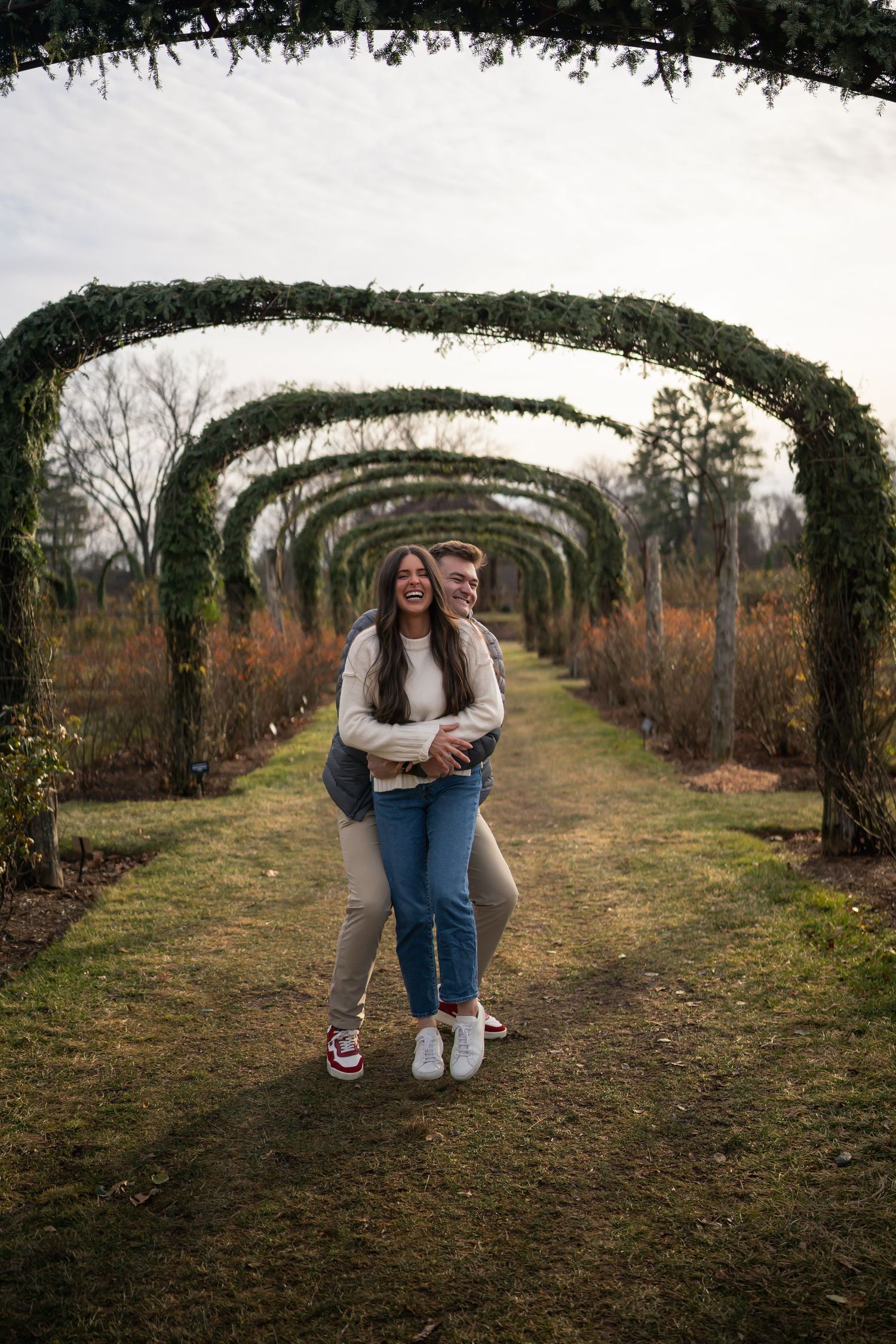 winter engagements photo session in elizabeth park photos of couple embracing from behind