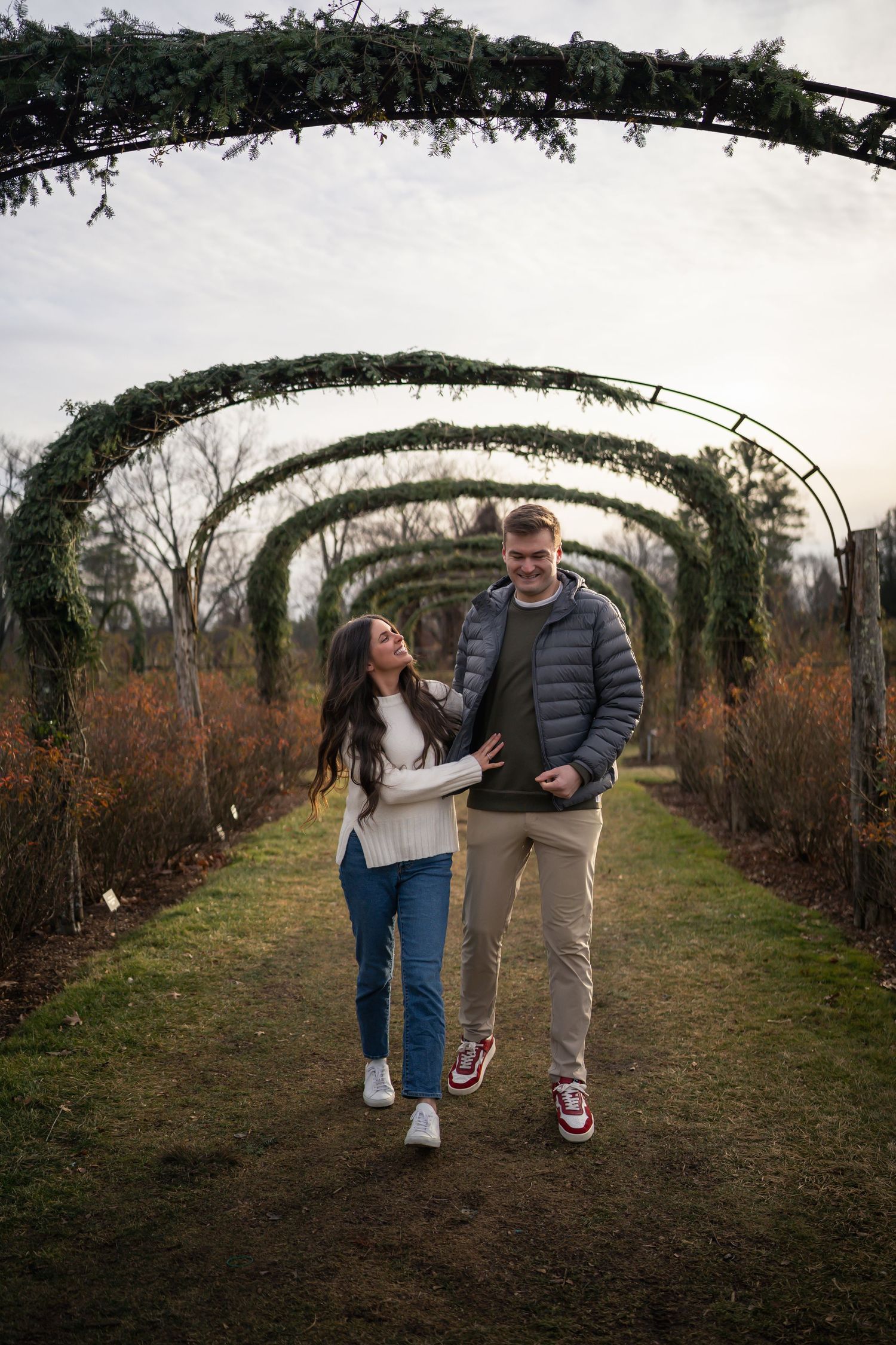 winter engagements photo session in elizabeth park photos of couple walking under flowers