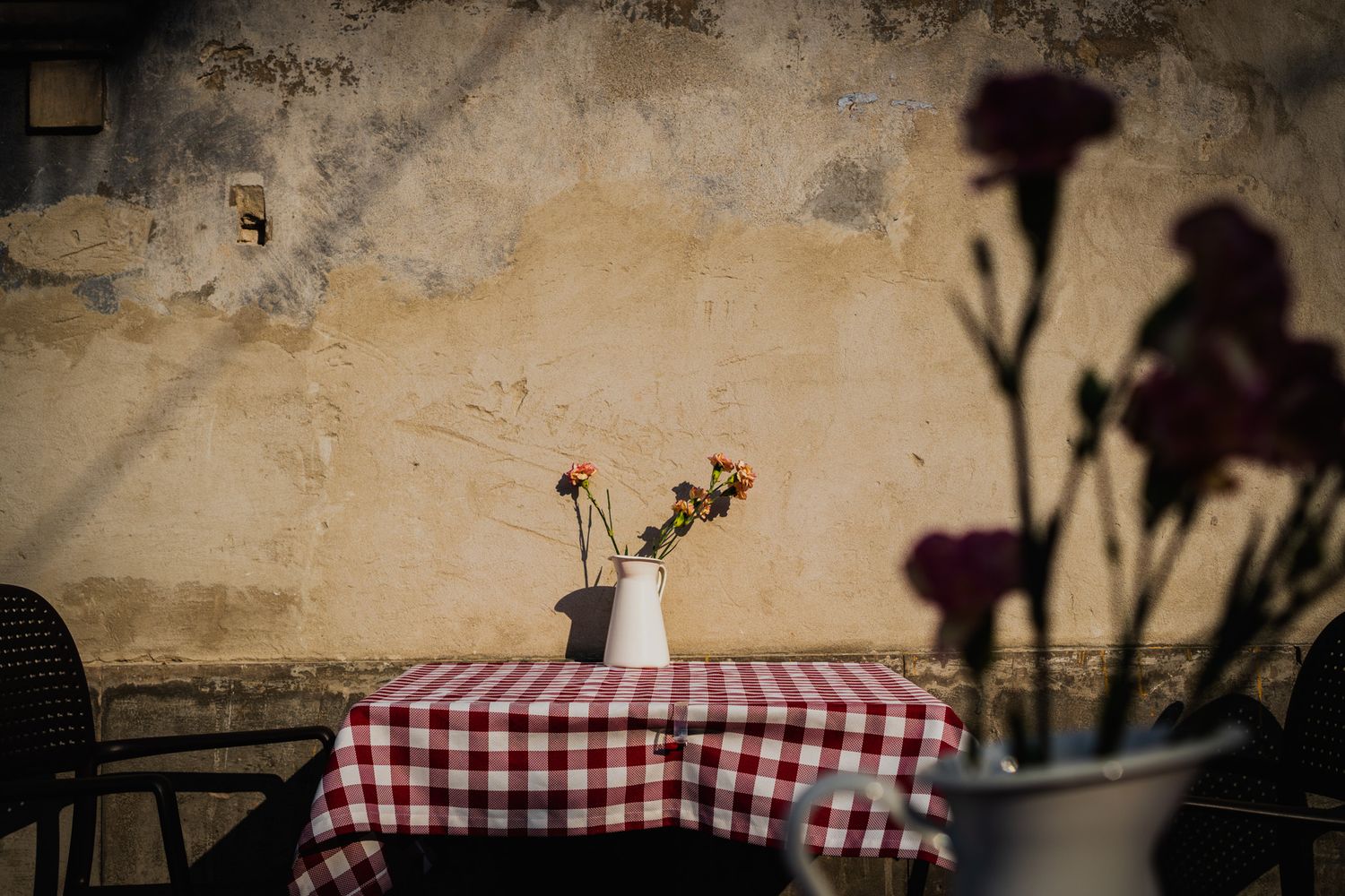 travel photo of beautiful checkered table spread in warsaw, poland old town with a flower centerpiece