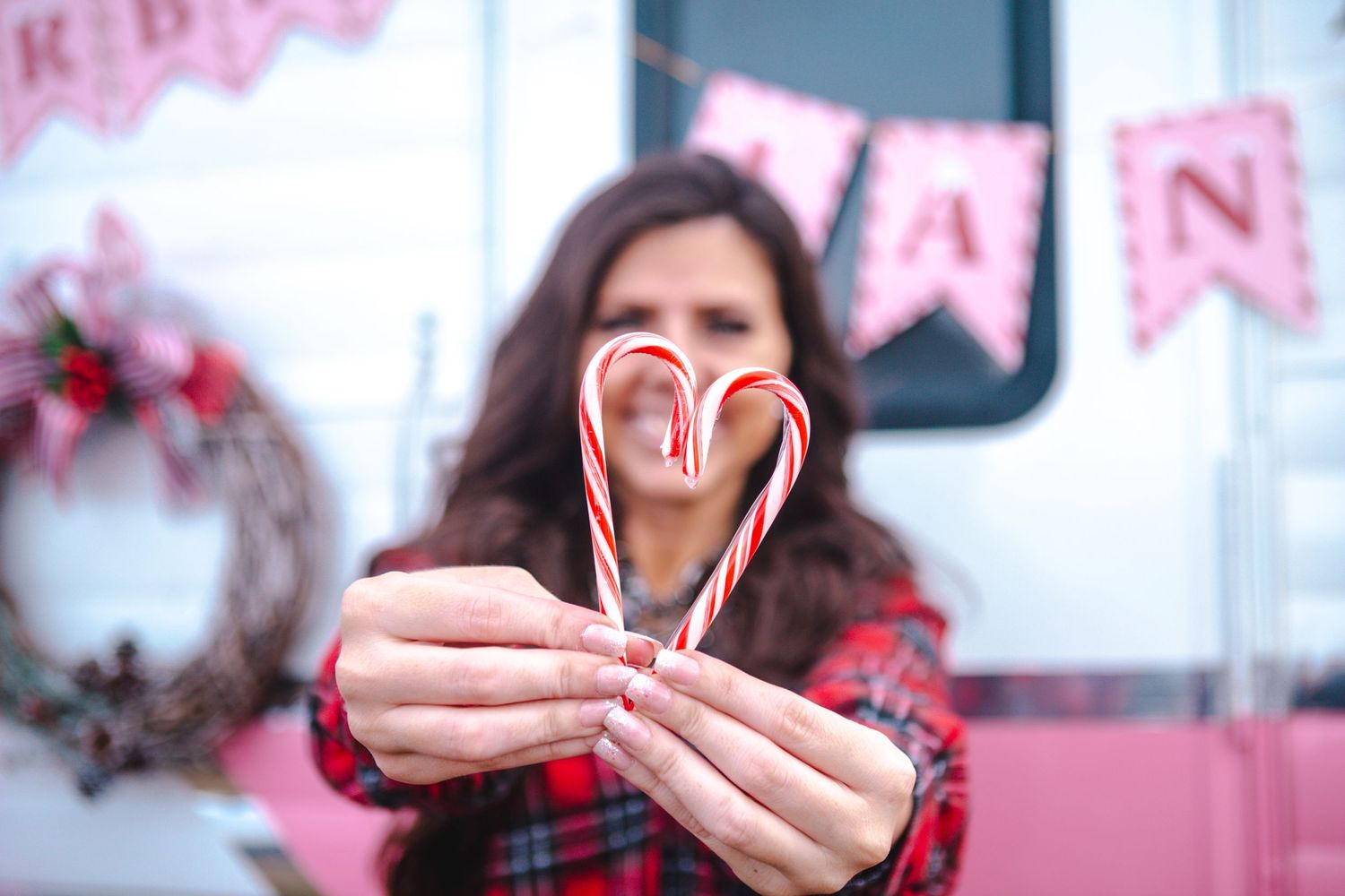 Festive holiday scene with candy canes and pink decorations.