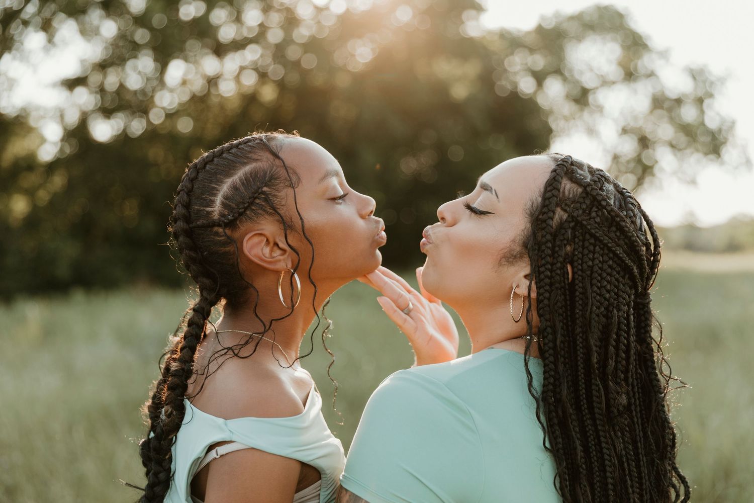Two friends share a joyful moment together in warm evening light.