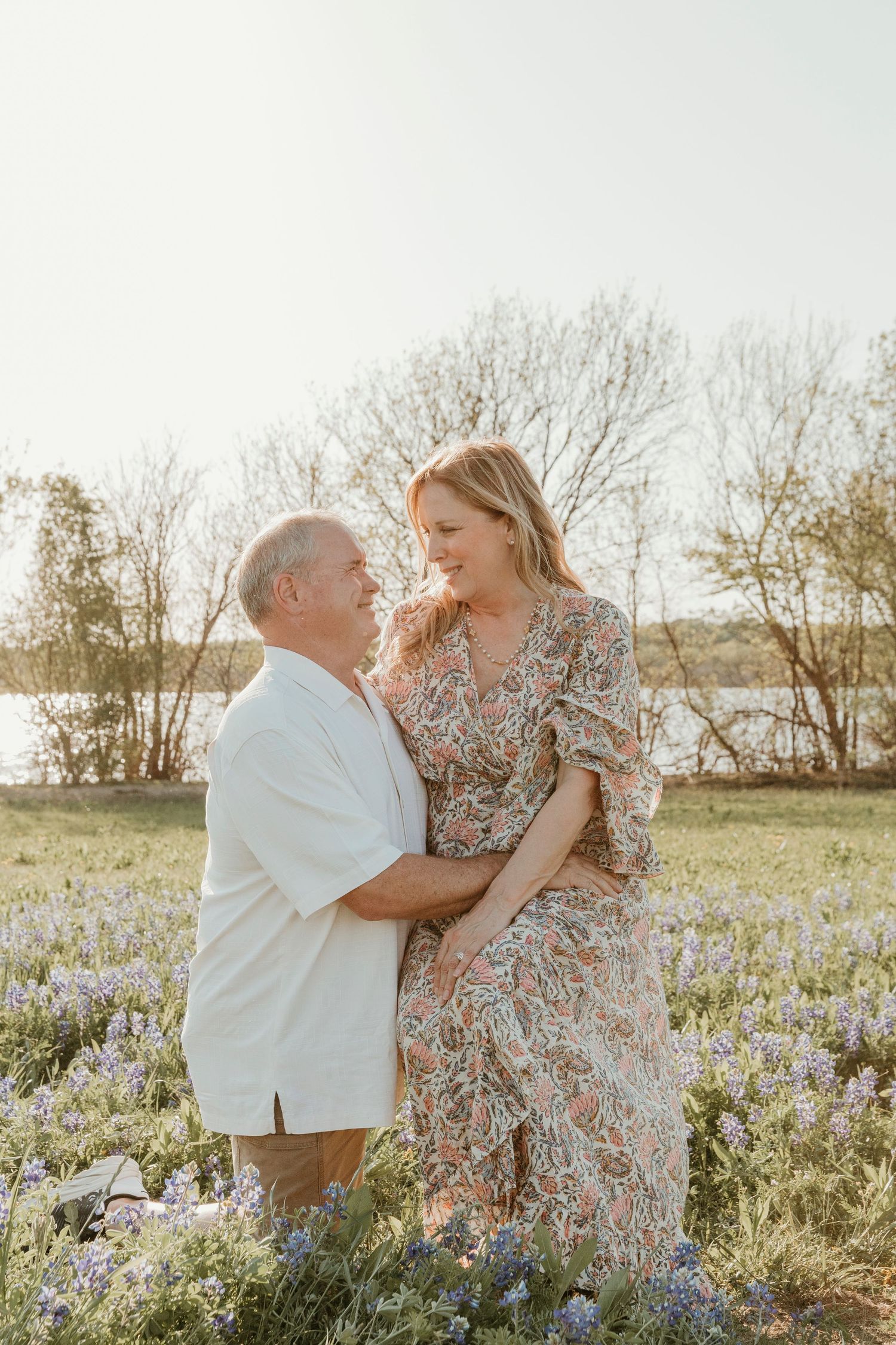 Couple sharing tender moments among wildflowers during a spring photoshoot.