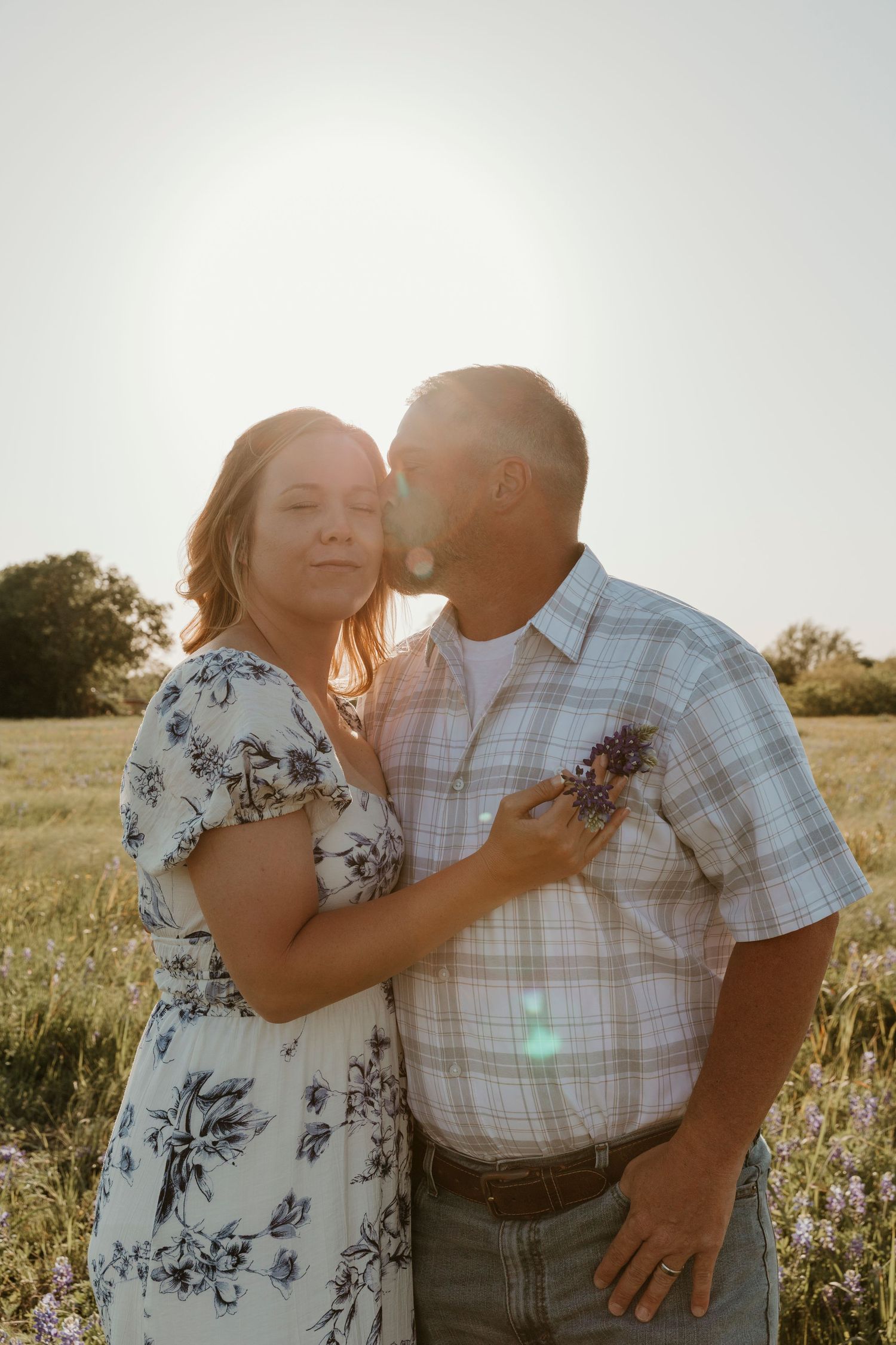 Romantic sunset portrait in wildflower field with soft natural lighting.