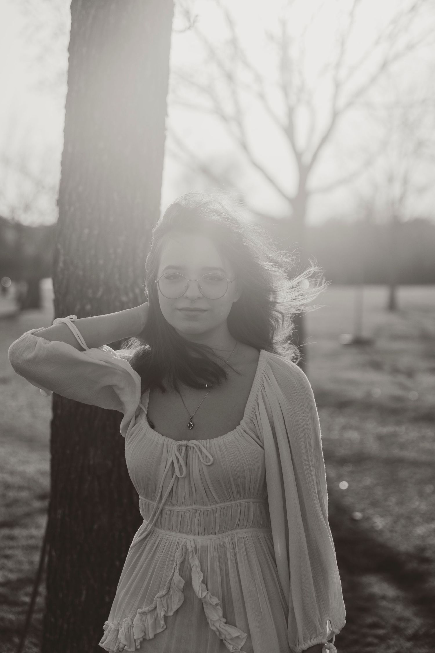 Ethereal black and white portrait shot in nature with dreamy sunlit atmosphere.