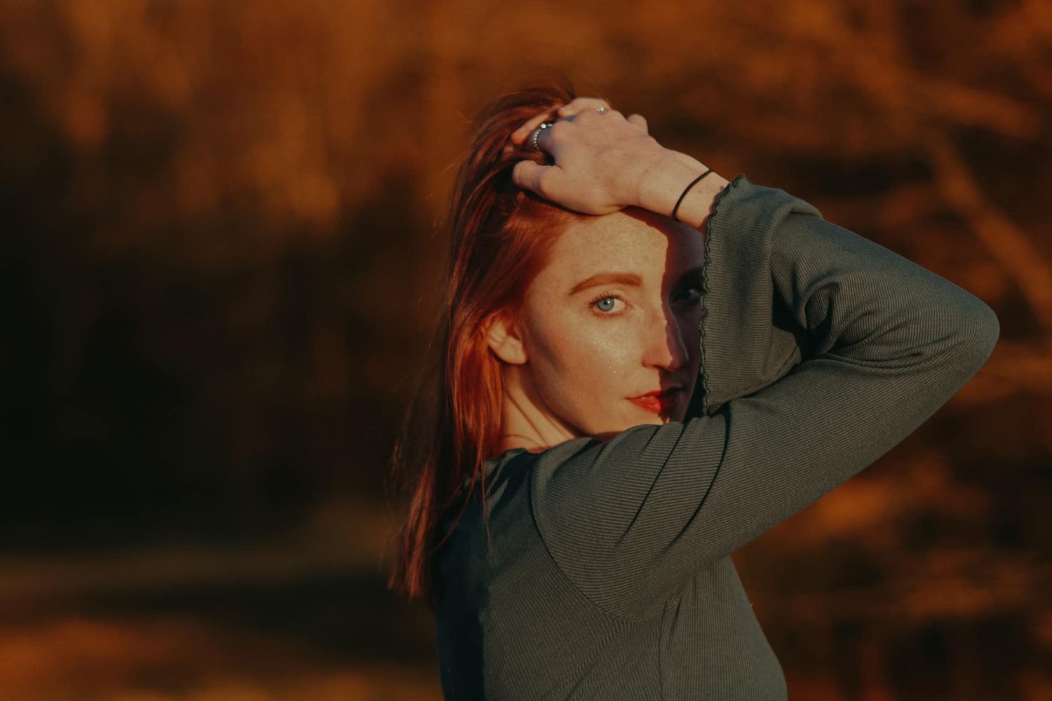 Warm sunset portrait in autumn tones with dramatic lighting and shadows.