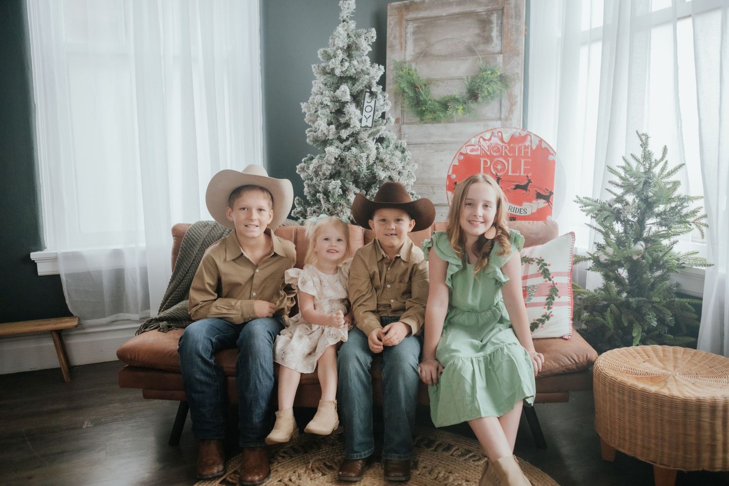 Cozy indoor family Christmas photo session with decorated tree and white decor.