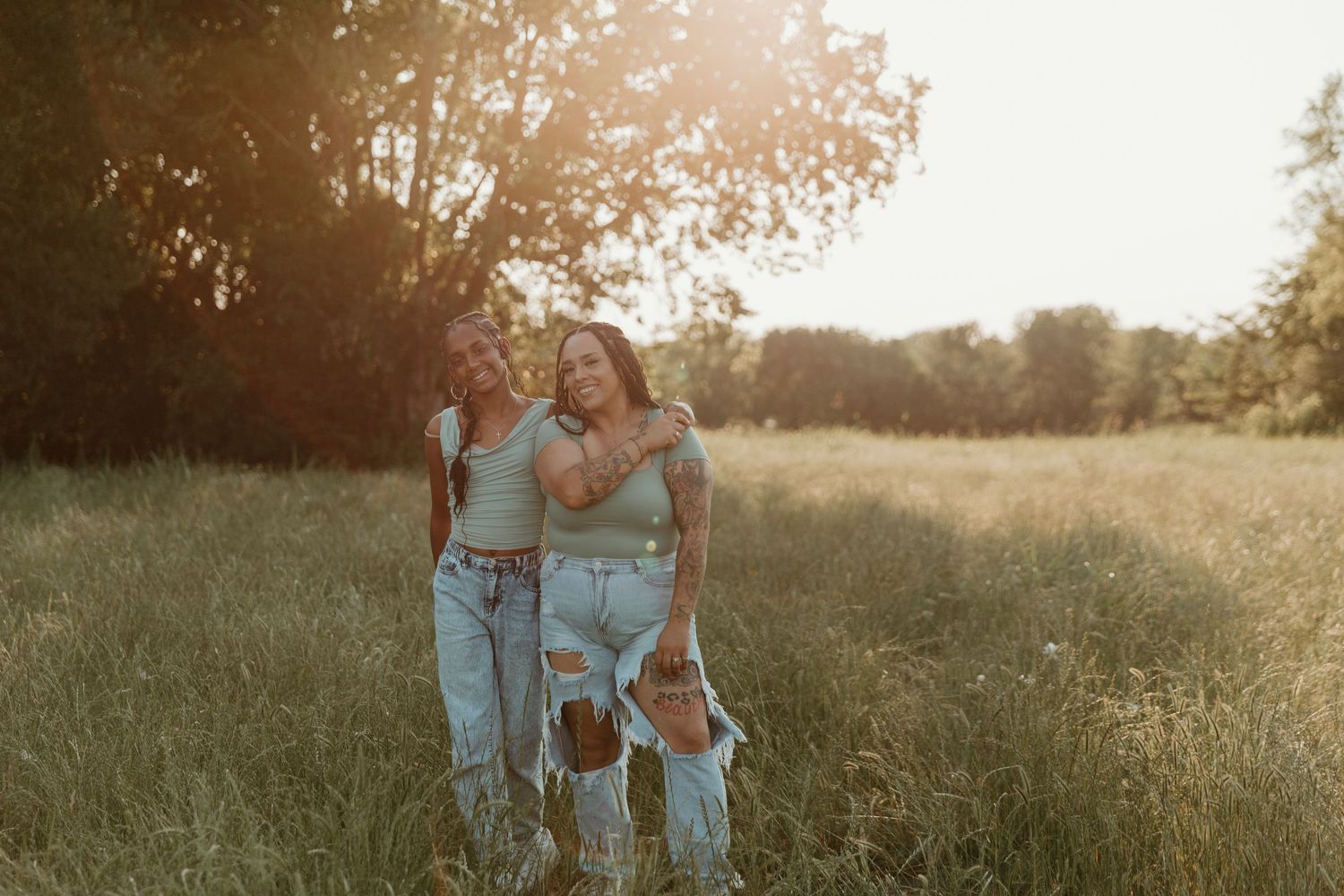 dancing together in an open field at dusk.