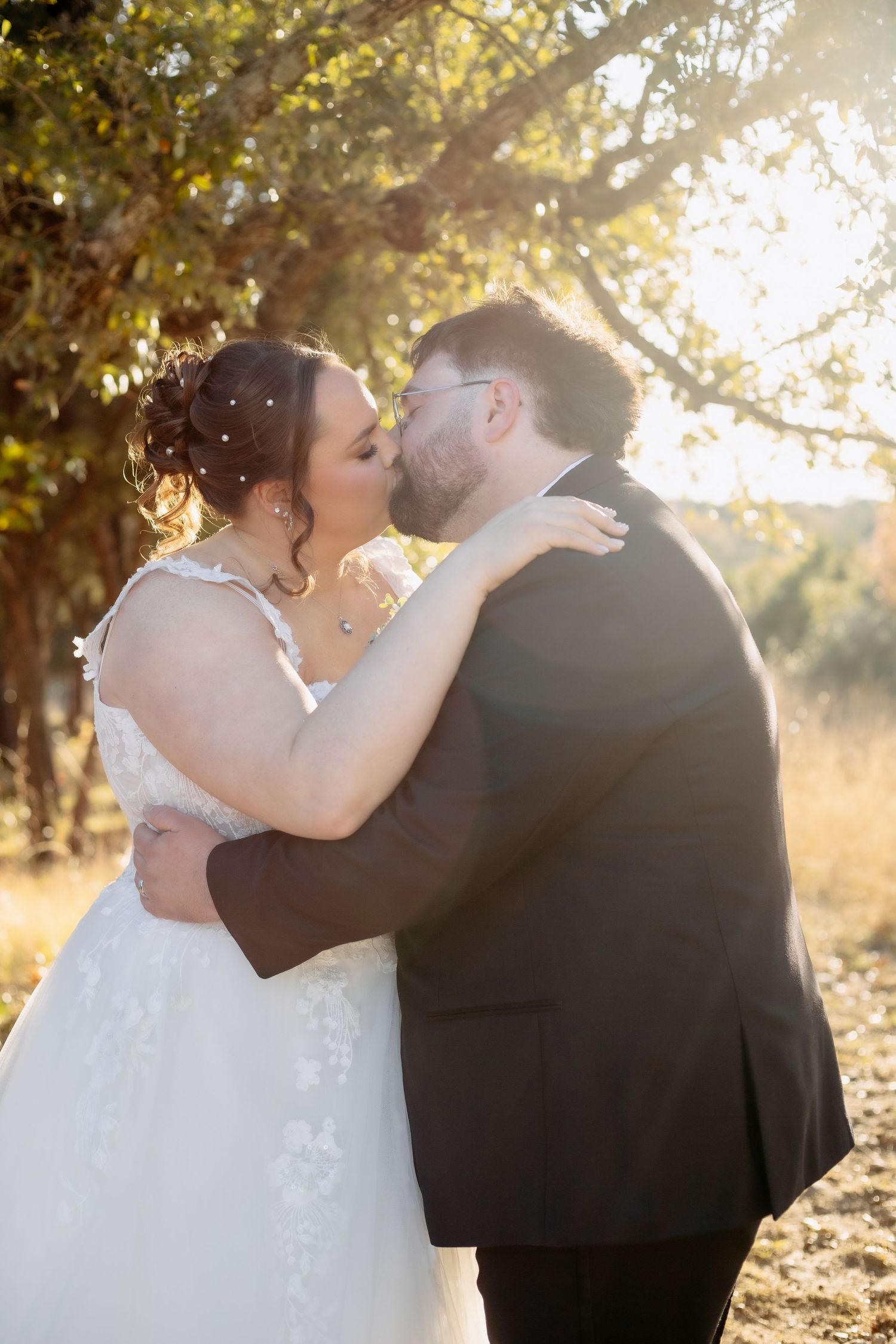 Newlyweds embrace during golden hour wedding photoshoot.