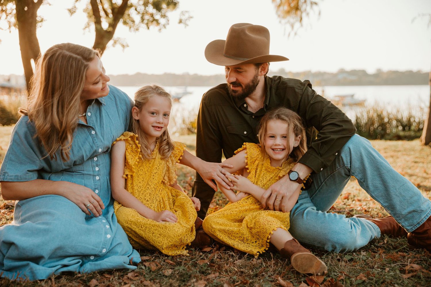 A family sits together outdoors during golden hour in a series of candid moments wearing blue and yellow clothing.