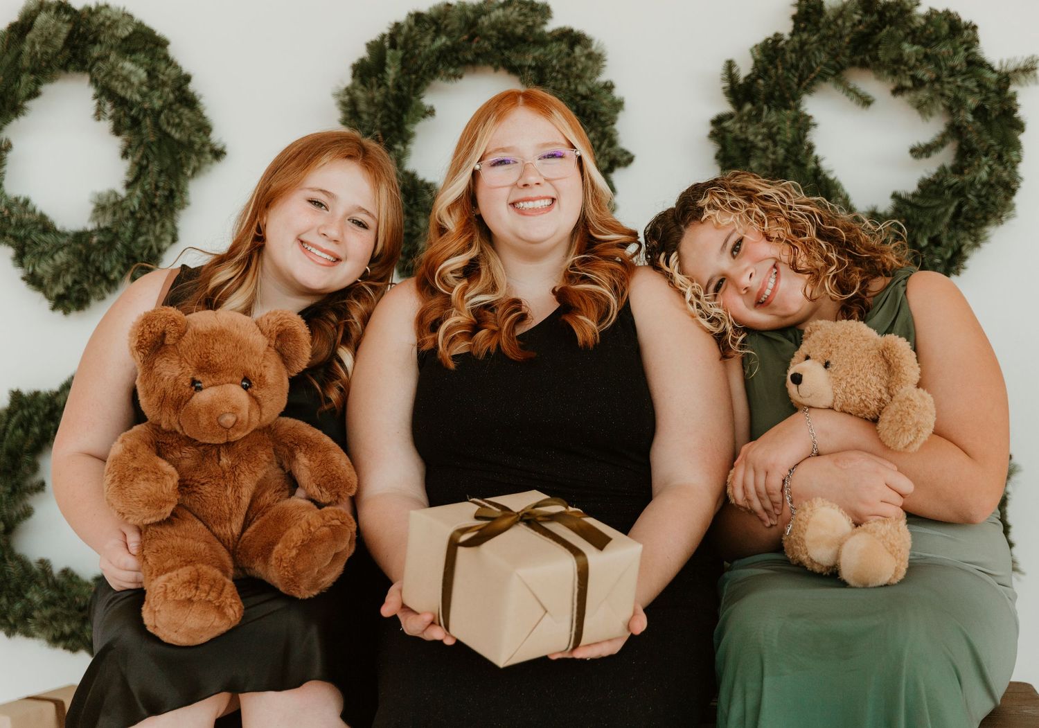 A creative photo collage showing people in green dresses holding brown teddy bears against a white background.