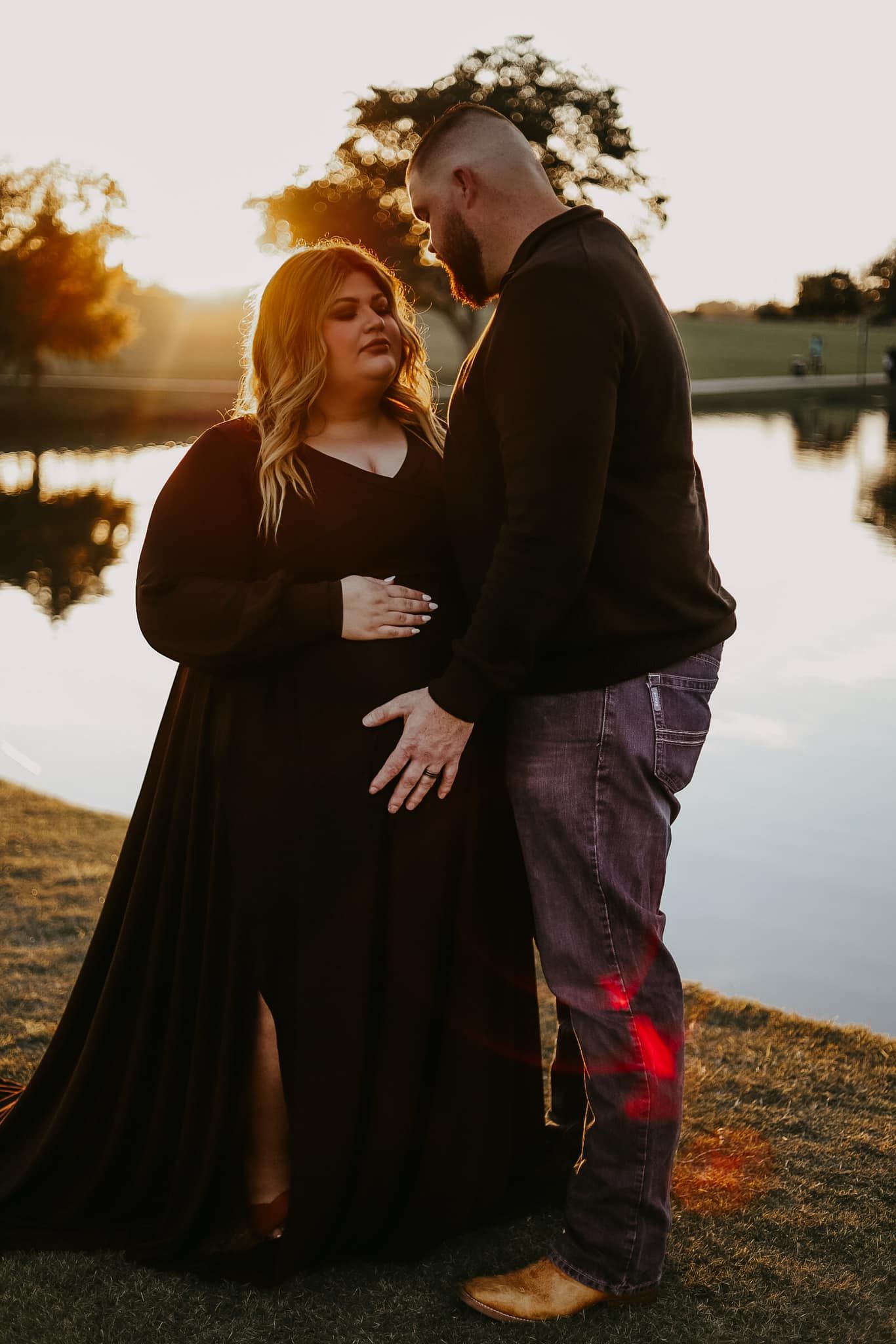 Intimate lakeside photography session during golden hour sunset.