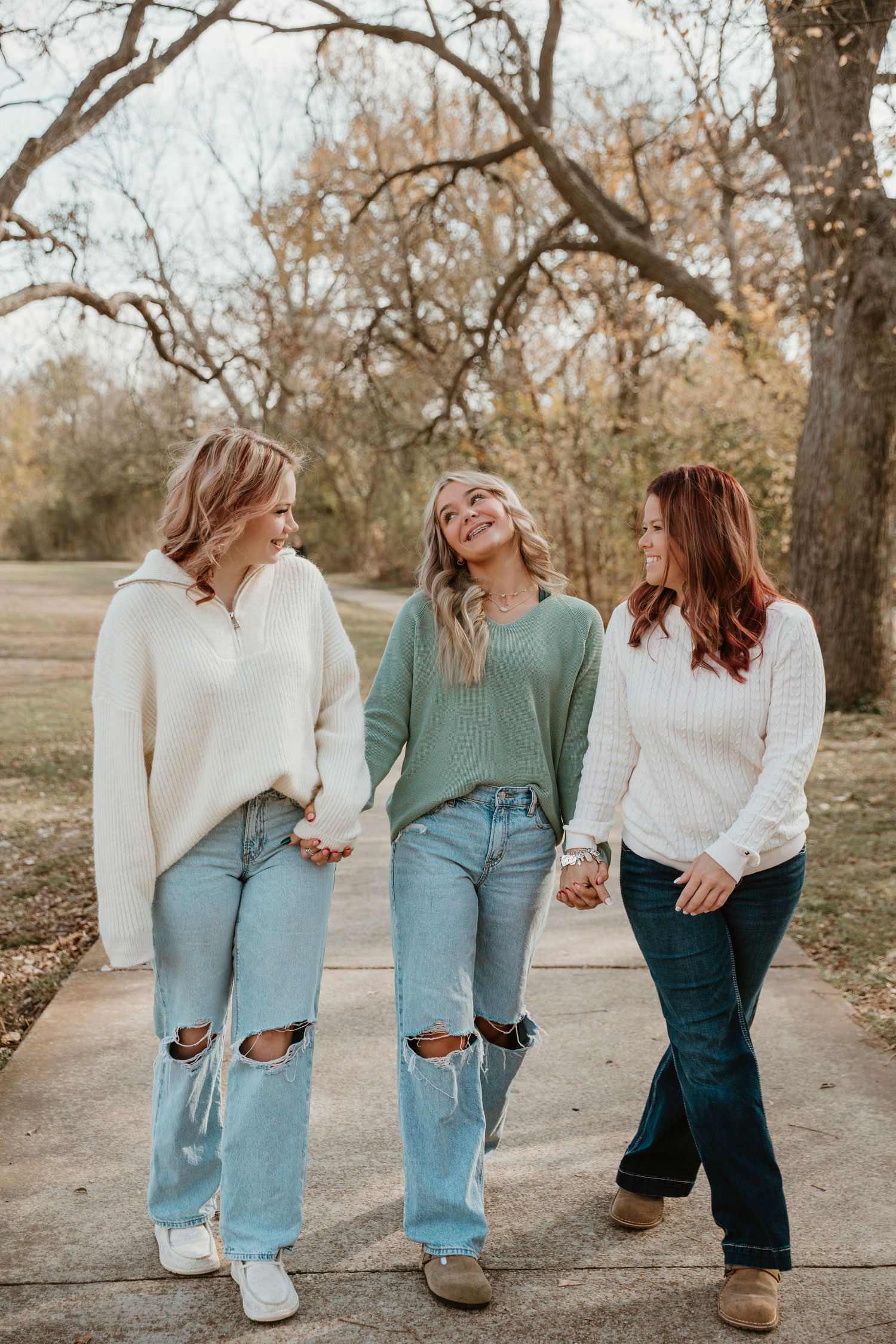 A series of candid photos showing friends laughing and walking together outdoors in jeans and sweaters on a fall day.
