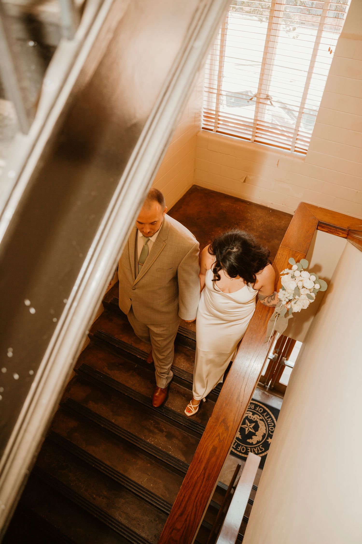 A sequence of sepia-toned wedding photos showing a couple ascending stairs in formal attire.