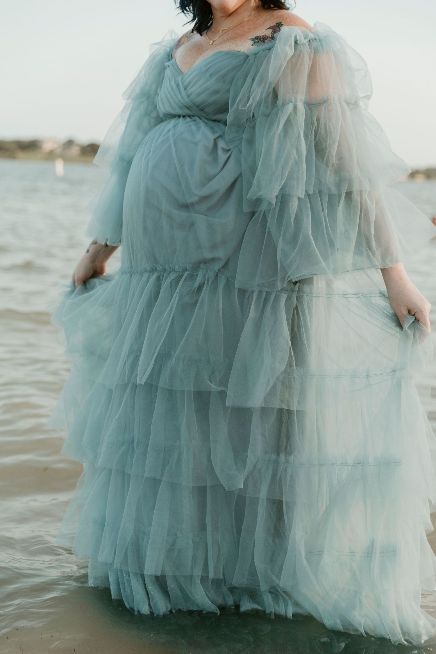 A flowing seafoam green tulle dress photographed in segments against an ocean backdrop.