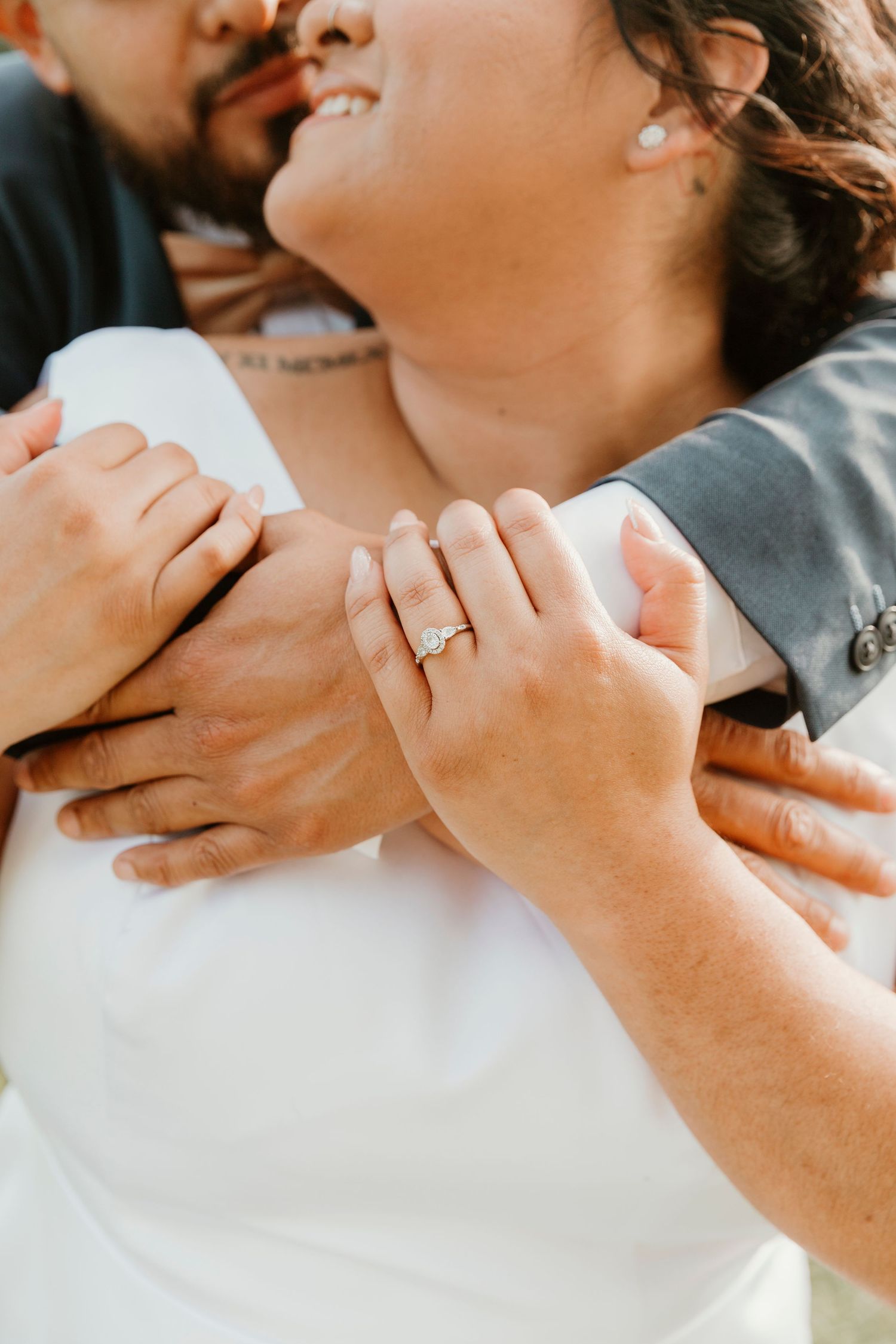 Close-up detail shots of tender embraces and a sparkling engagement ring.